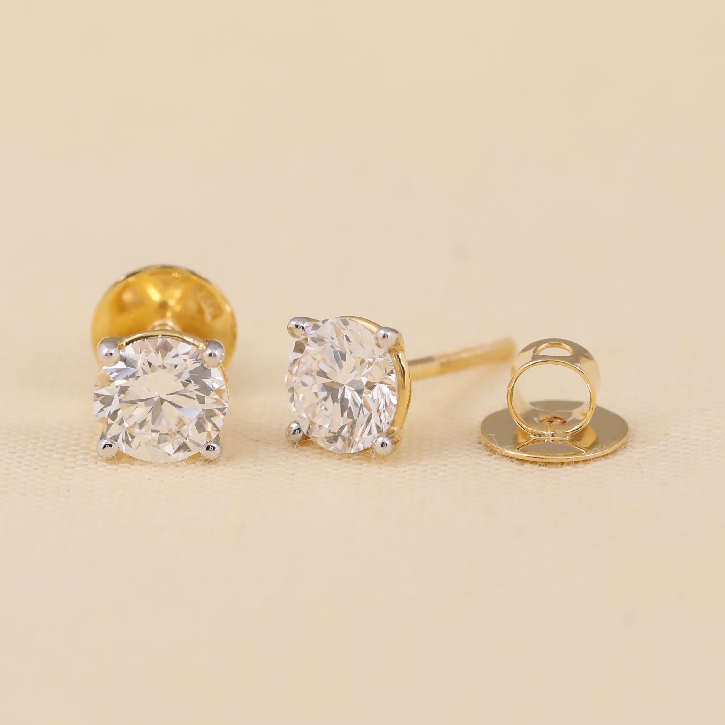 Round diamond stud earrings crafted for party wear or celebrations.