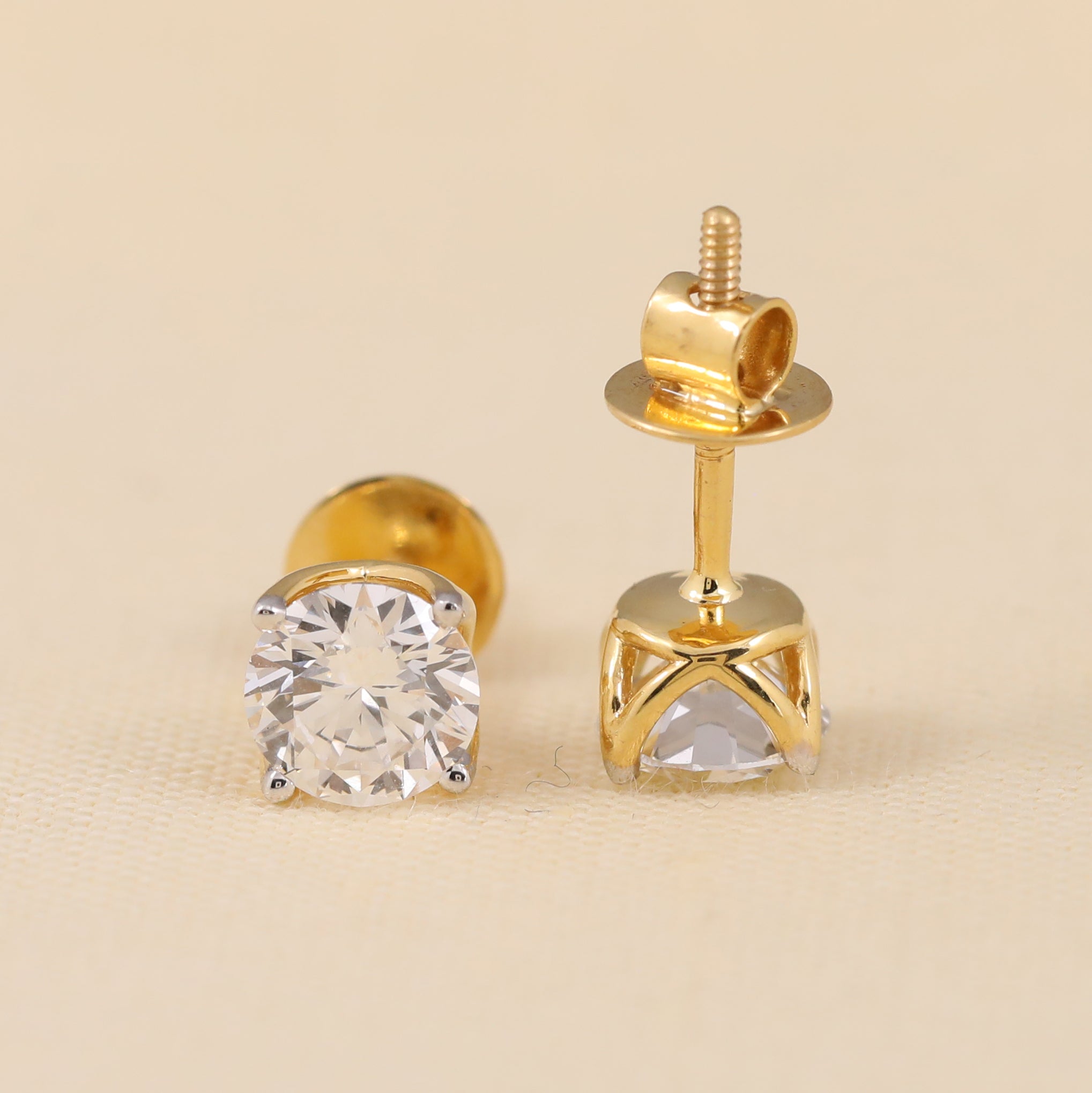 Classic round cut diamond earrings suited for daily wear or gifting.