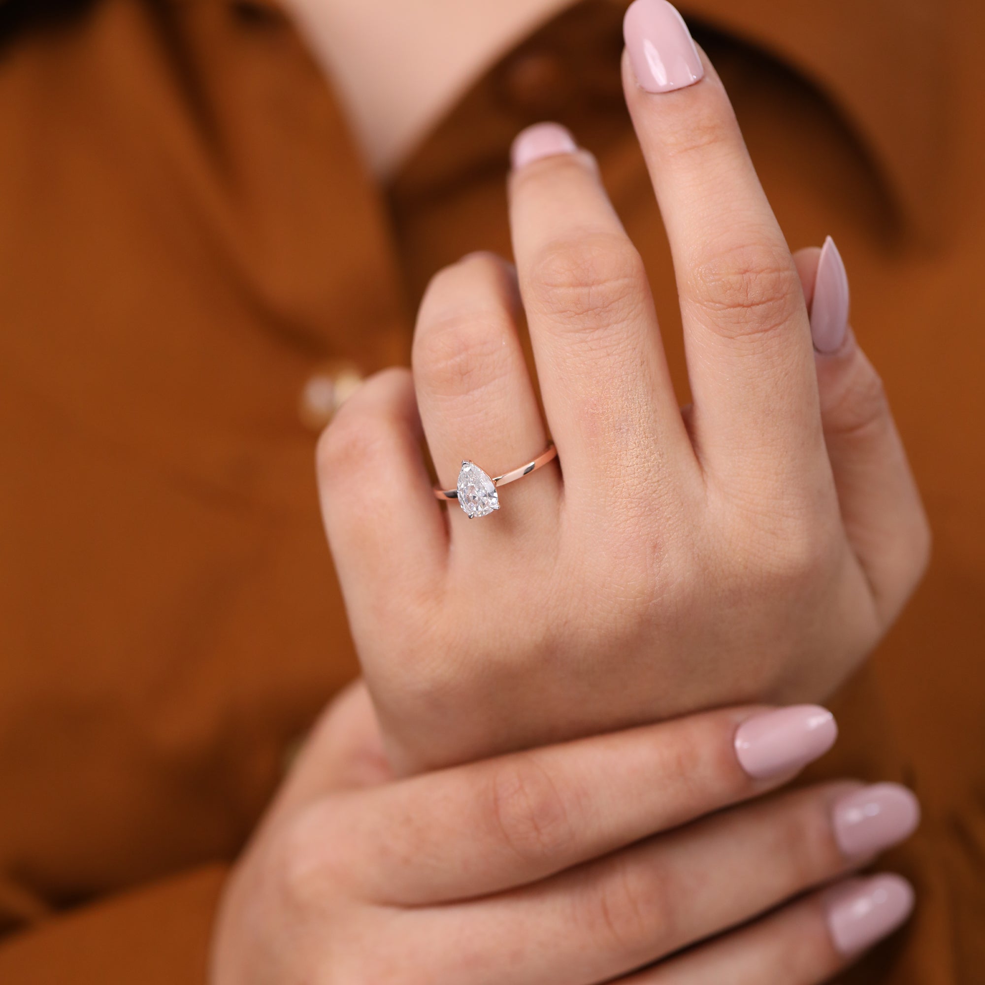 Elegant solitaire engagement ring featuring a pear cut lab grown diamond