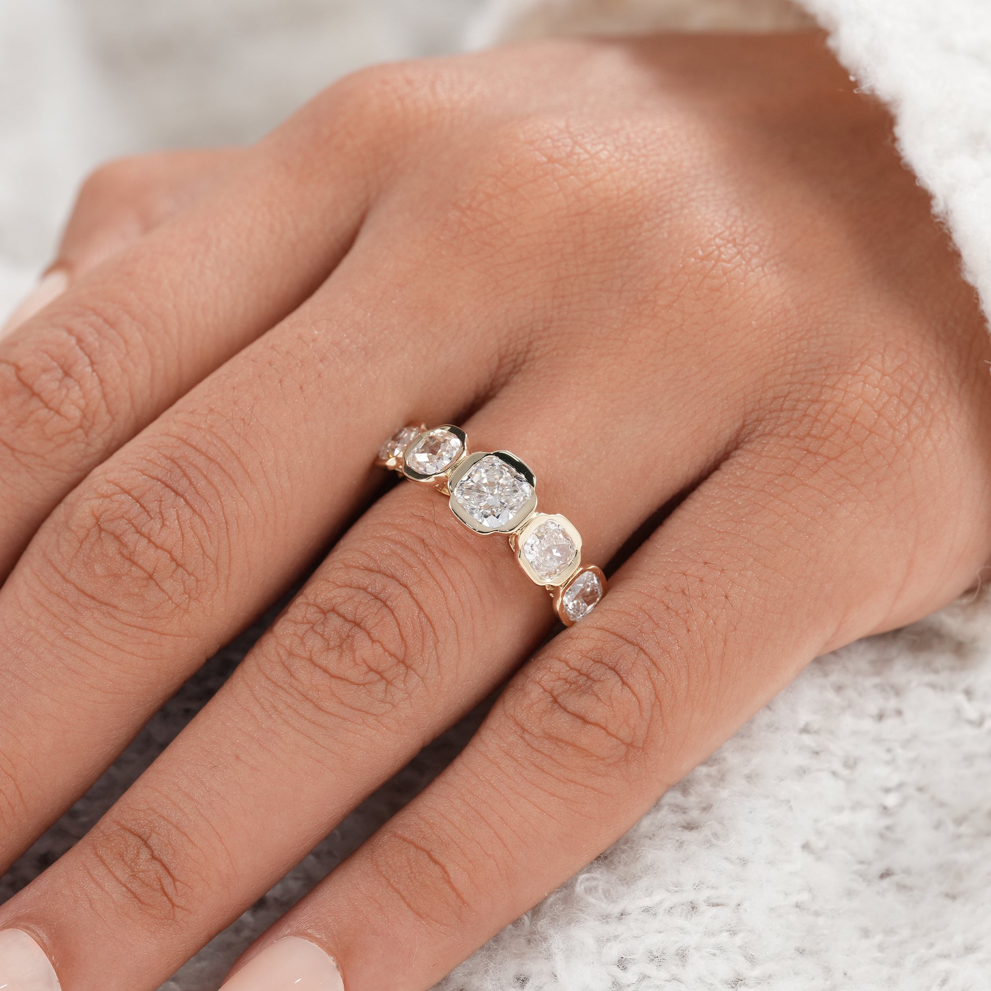 Five stone diamond bridal band with a larger center cushion diamond.