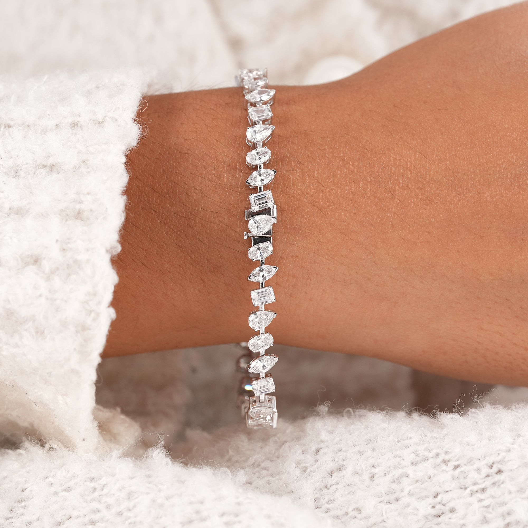 IGI certified diamond bracelet with emerald and marquise lab diamonds.