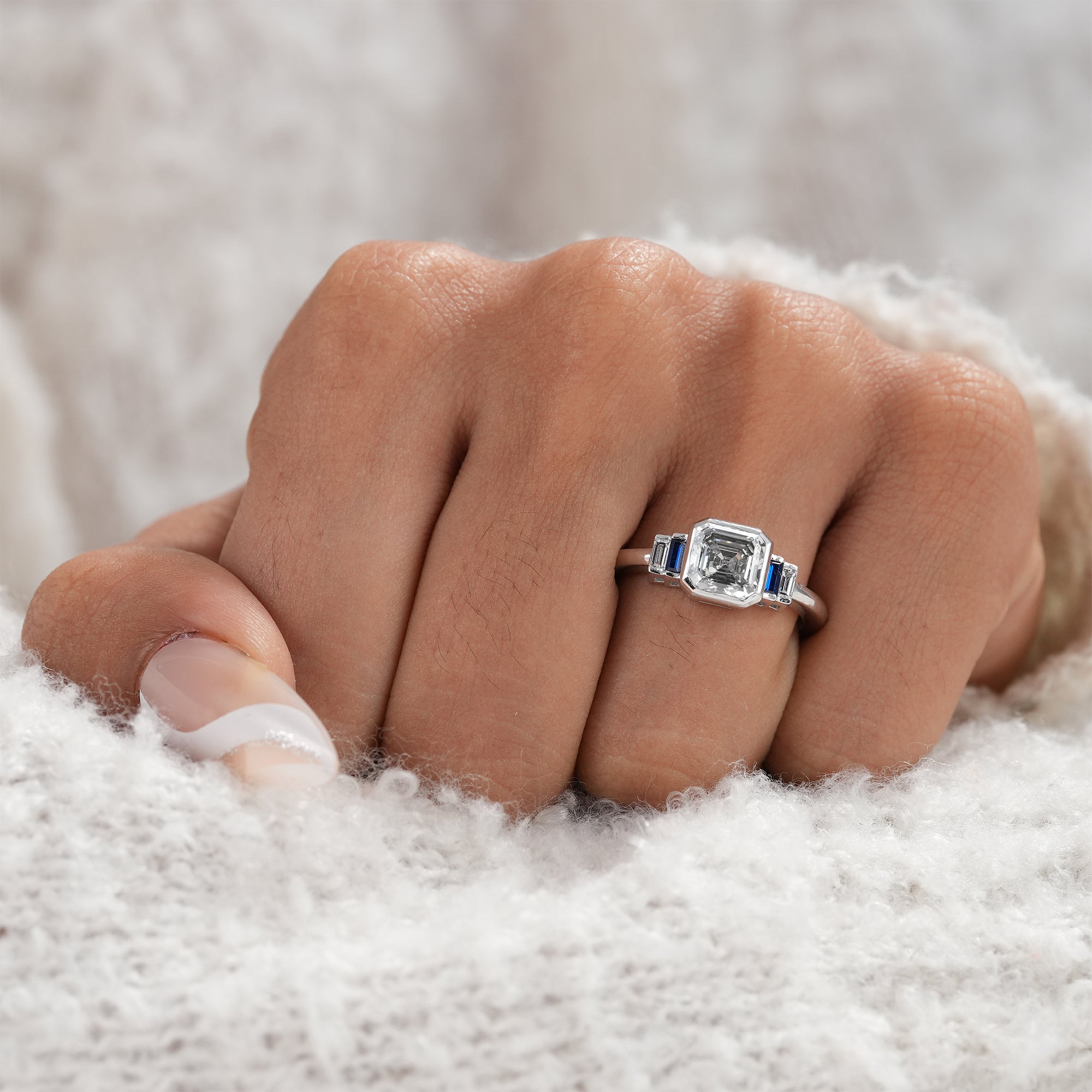 Minimalist Asscher cut diamond ring with sapphire baguettes.