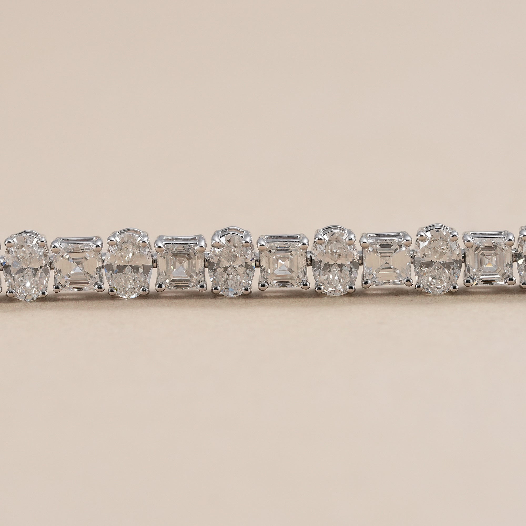 Oval and asscher cut diamond bracelet in white gold.