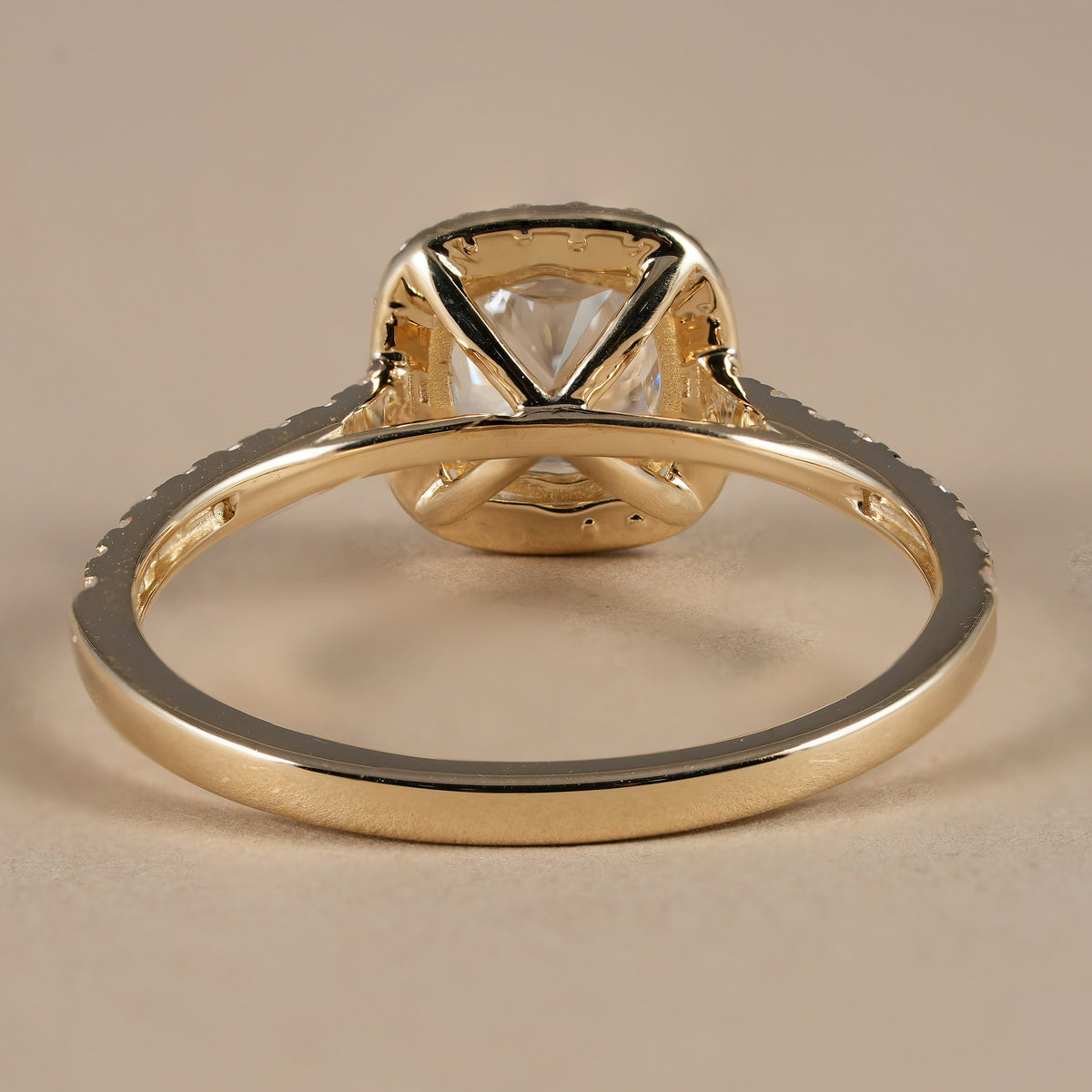 Cushion cut bridal ring showcasing a brilliant halo and pavé diamond shank for exceptional sparkle.