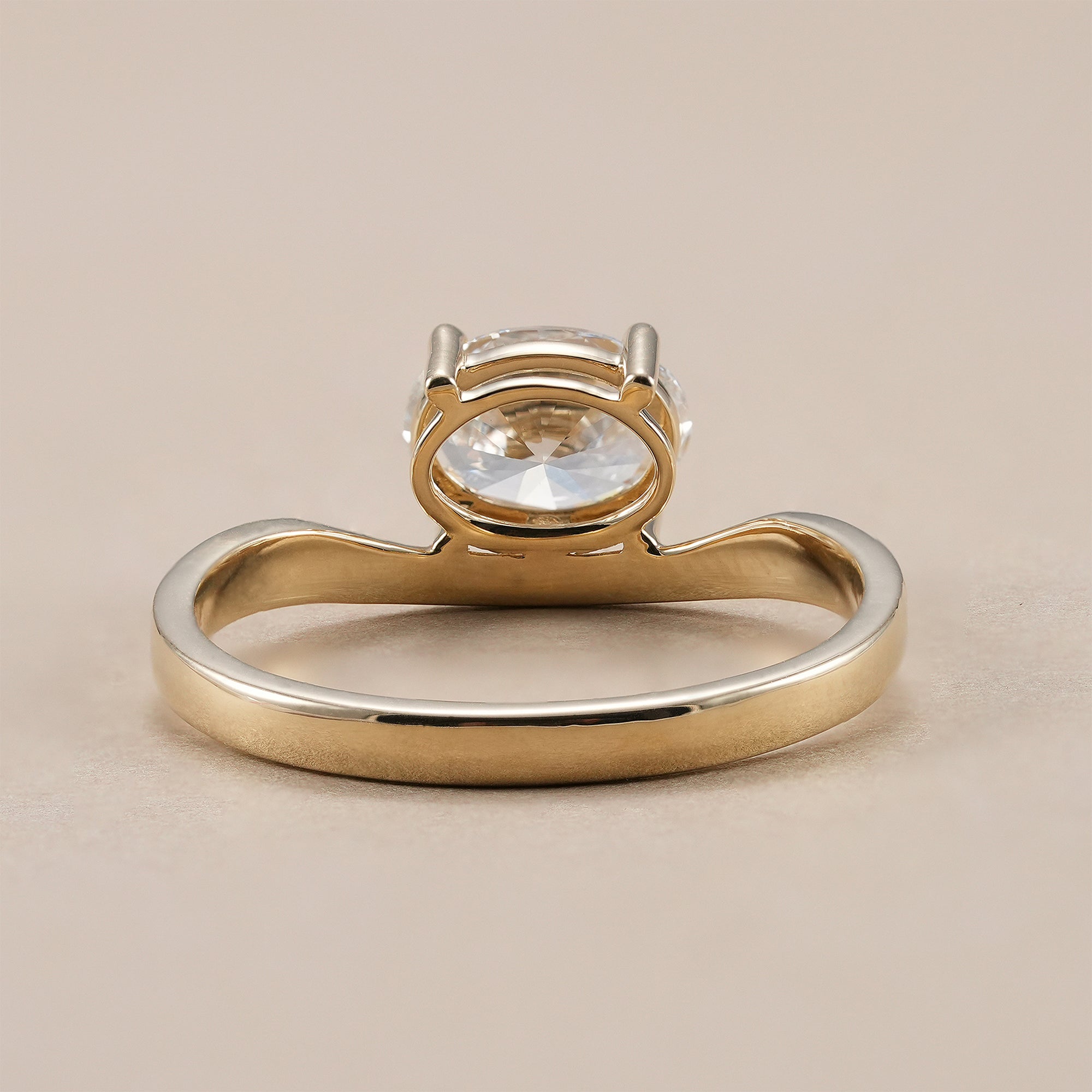 Elegant chevron engagement ring featuring oval cut diamond.