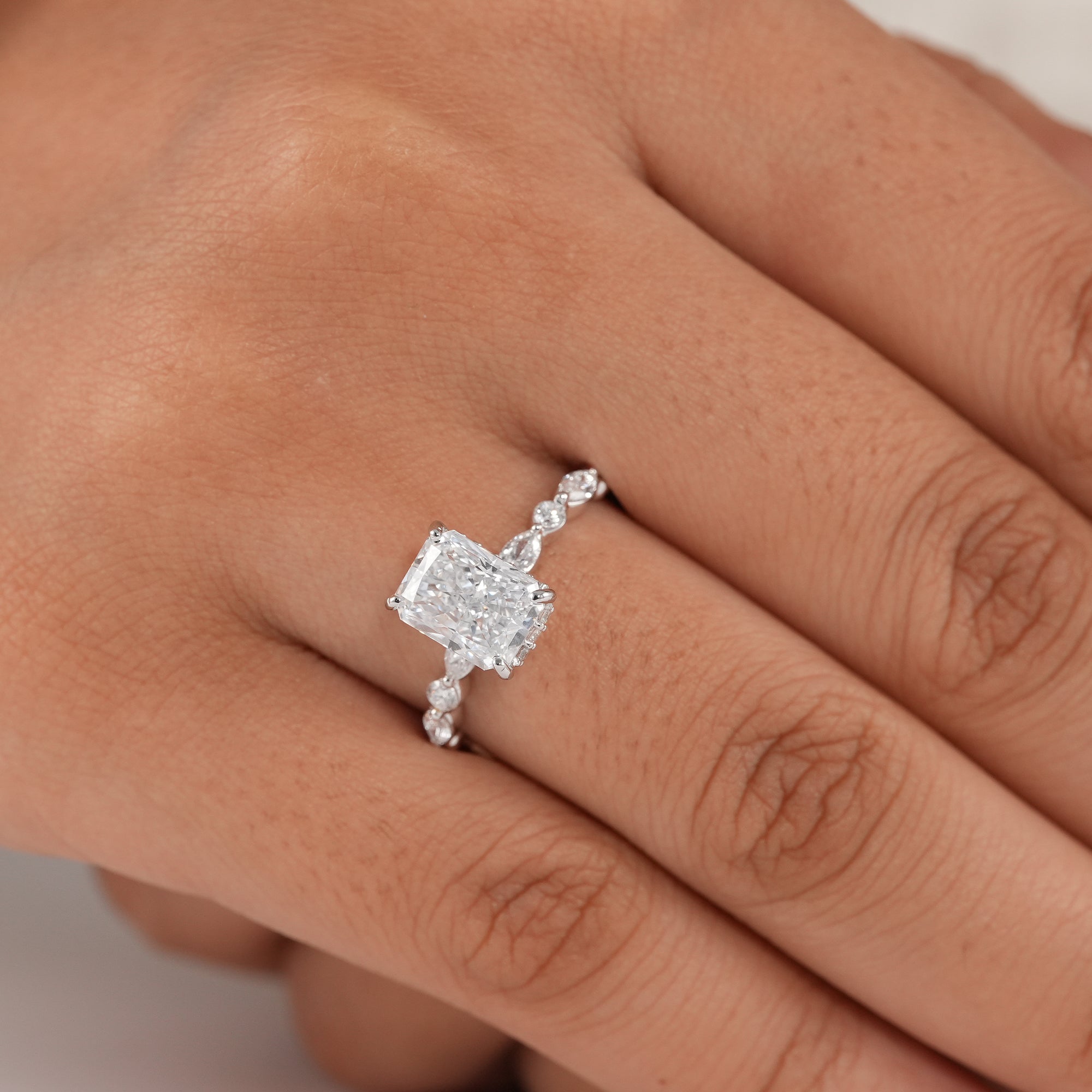 Radiant cut solitaire ring with hidden halo setting.