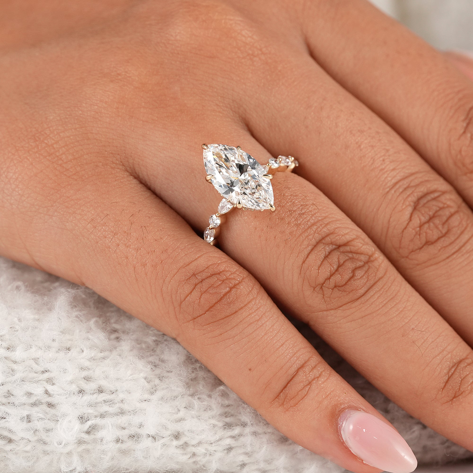 Marquise engagement ring featuring alternating round diamonds