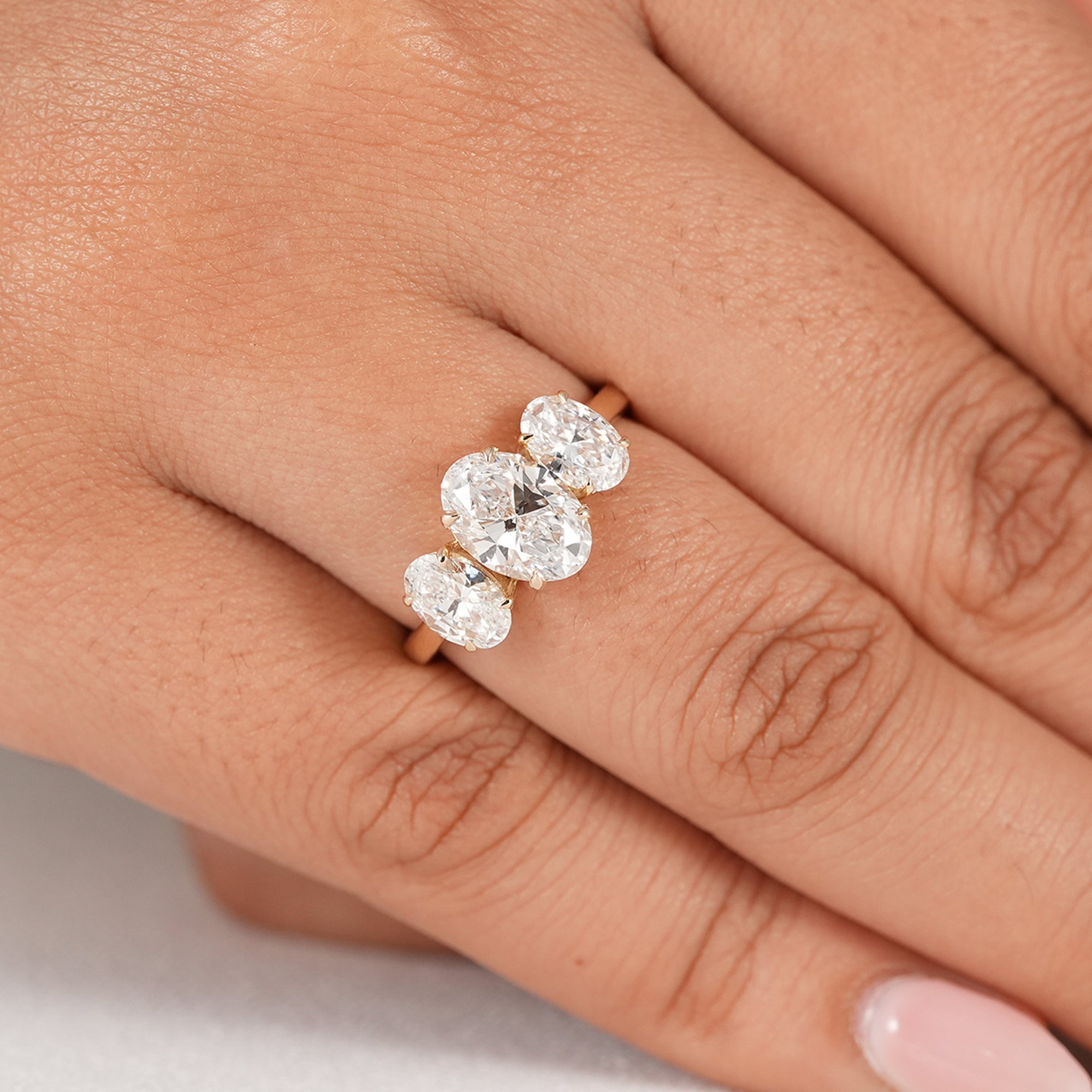 Three stone oval diamond wedding ring in gold