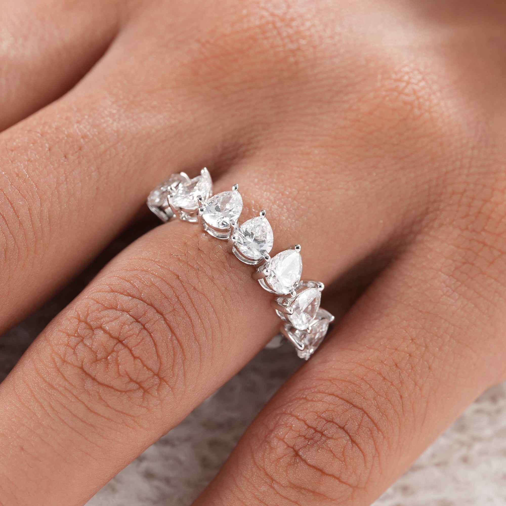 Half eternity pear diamond wedding ring with brilliant sparkle.