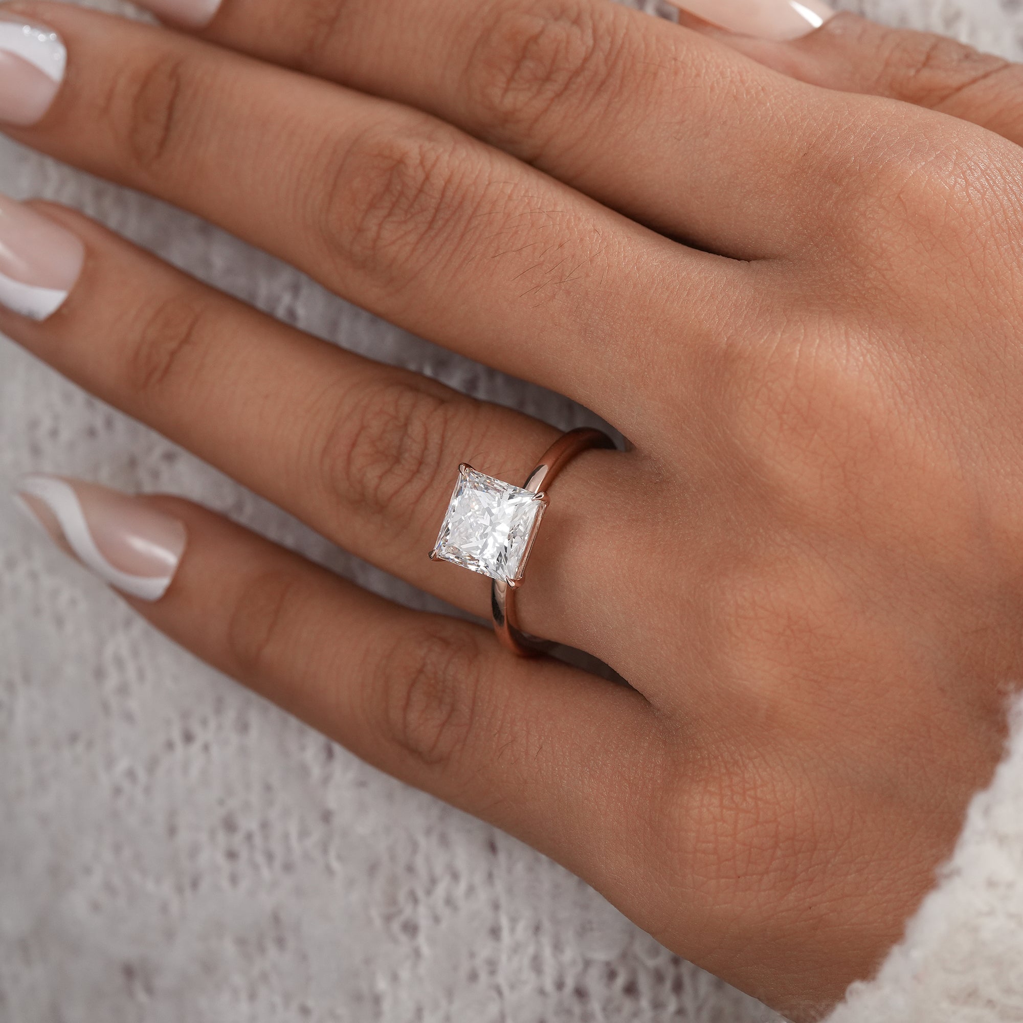 Fine jewelry princess cut solitaire ring in polished rose gold.