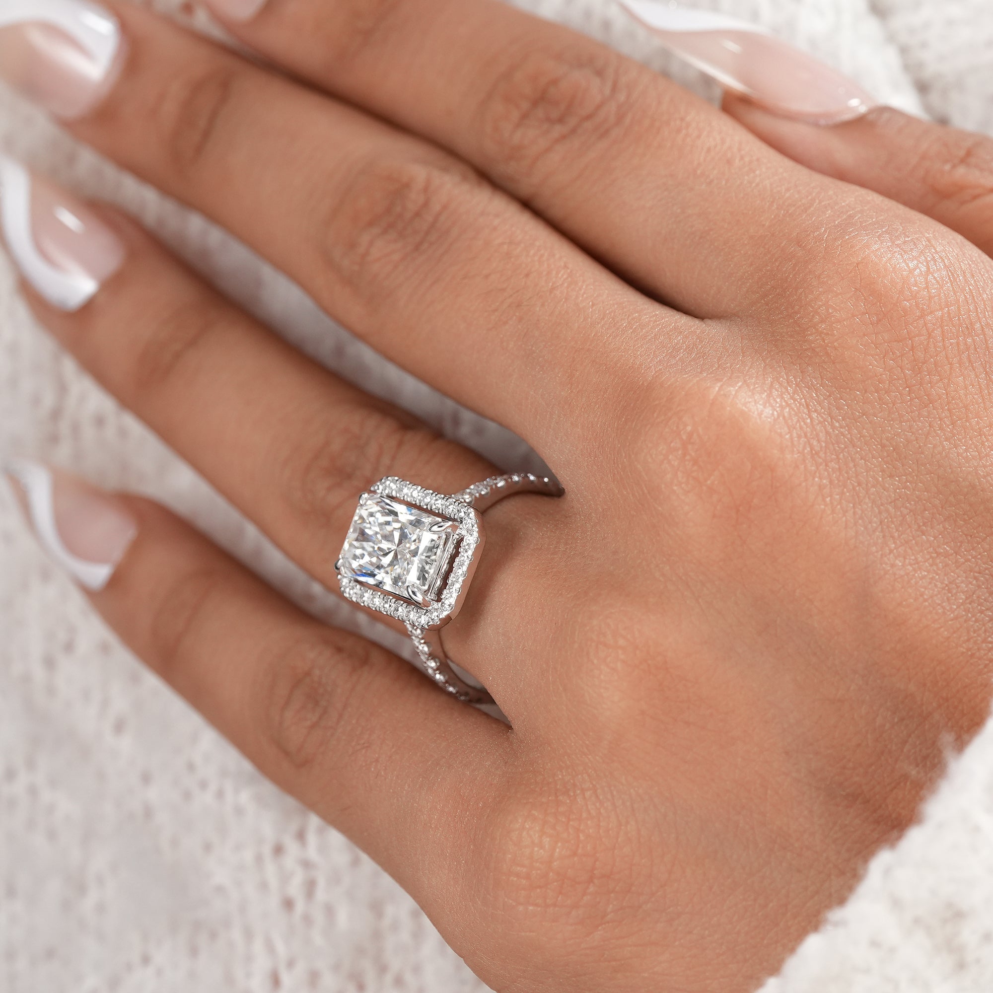 Elegant radiant diamond halo ring handcrafted in white gold.