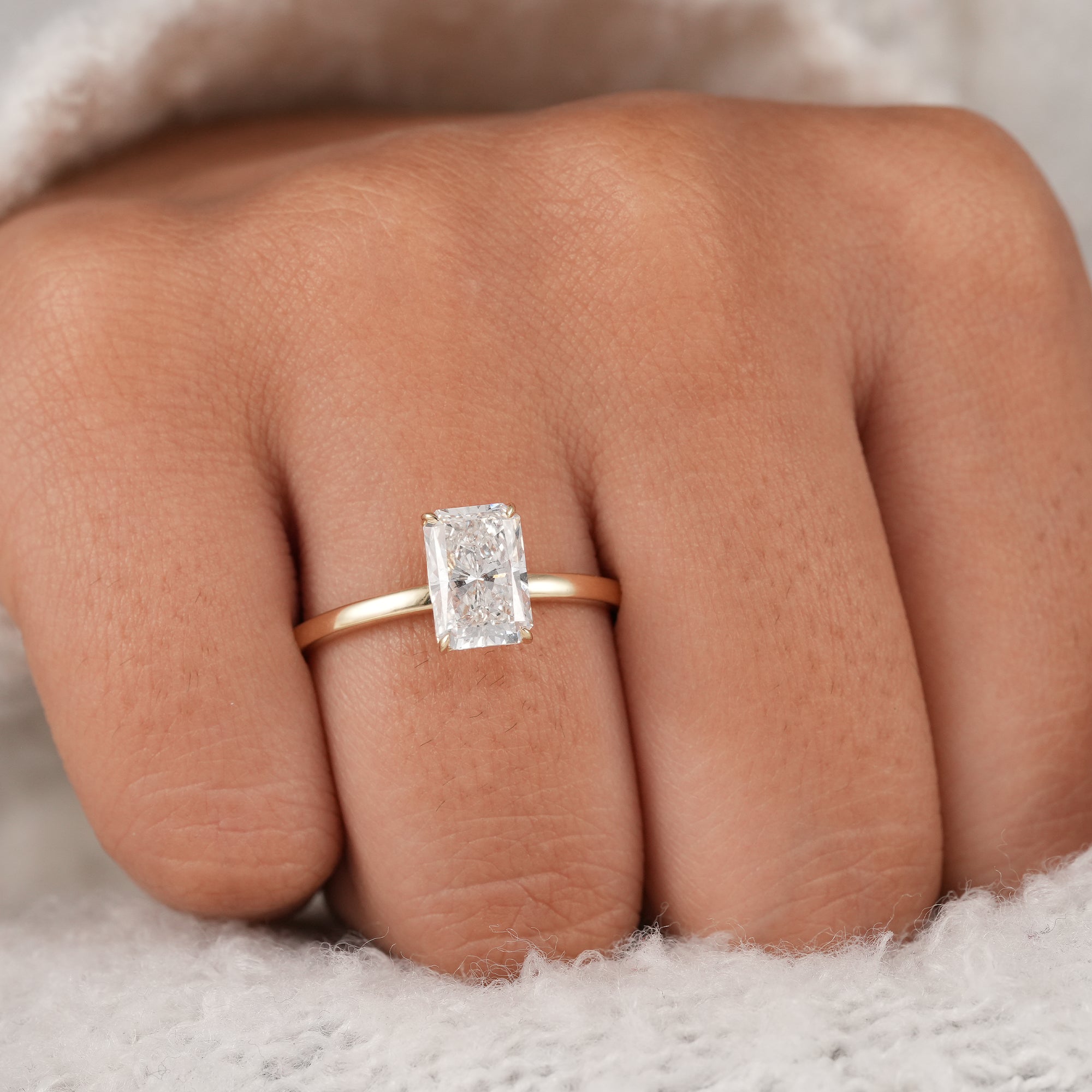 Fine jewelry radiant diamond engagement ring close-up.