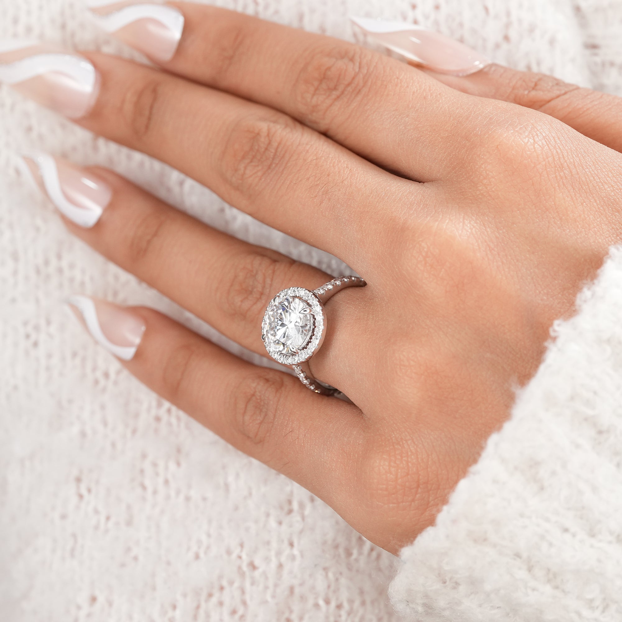 Elegant round halo engagement ring handcrafted in white gold.