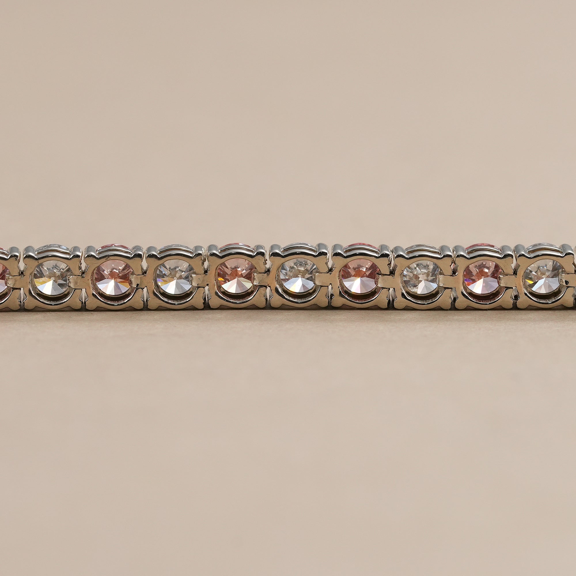 Handcrafted white and pink diamond tennis bracelet with secure clasp.