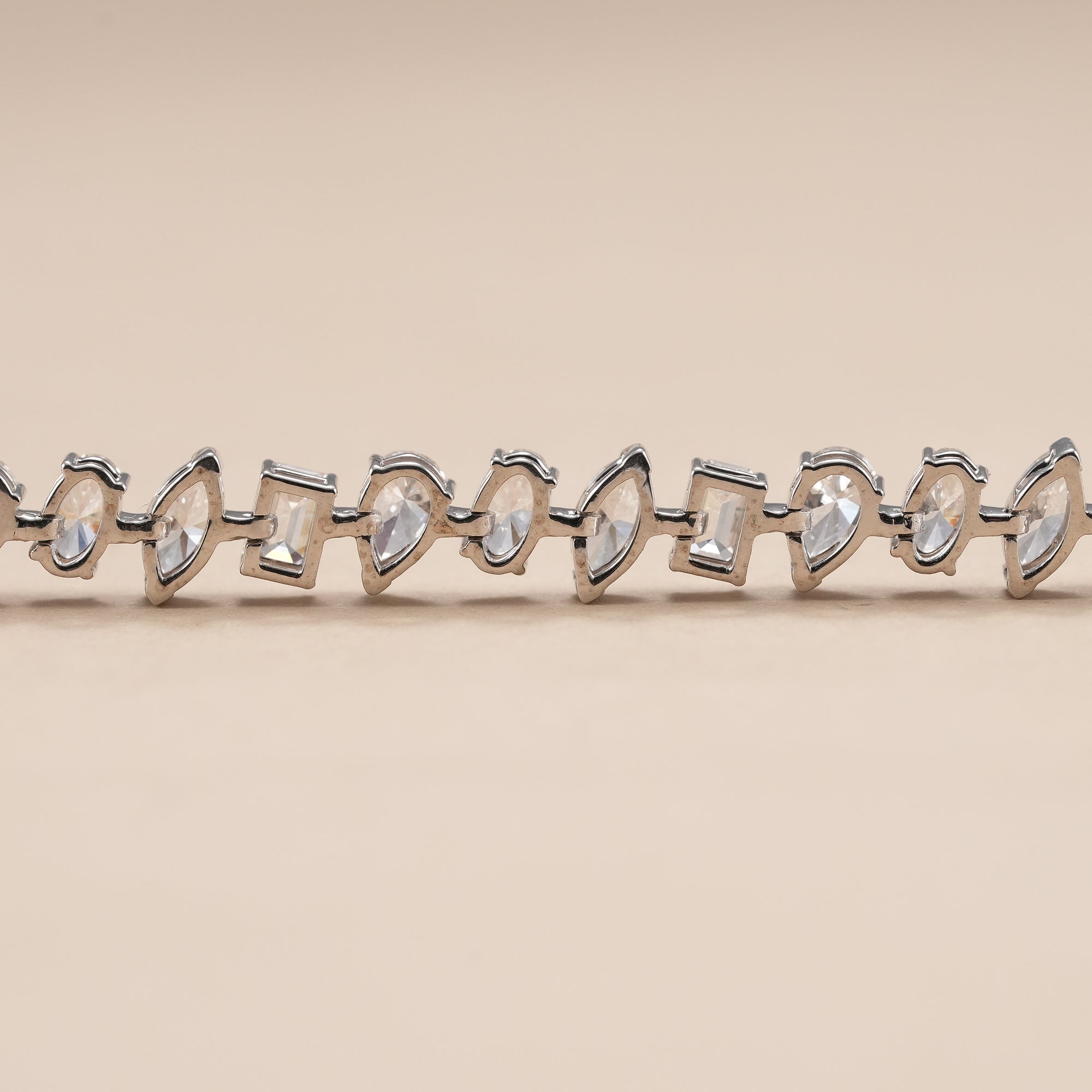 Bridal tennis bracelet with emerald, pear, oval and marquise diamonds.