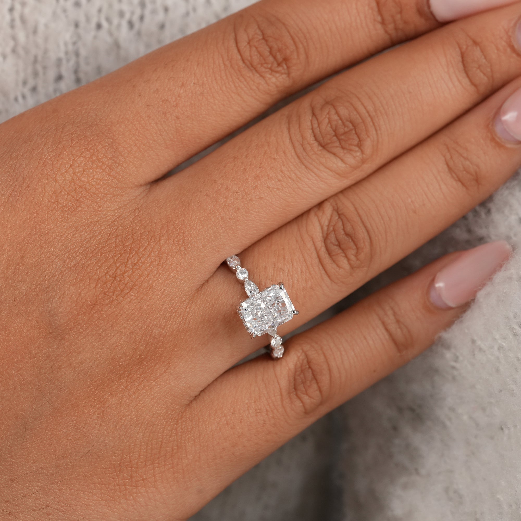 Handmade radiant diamond engagement ring with alternating diamond band.