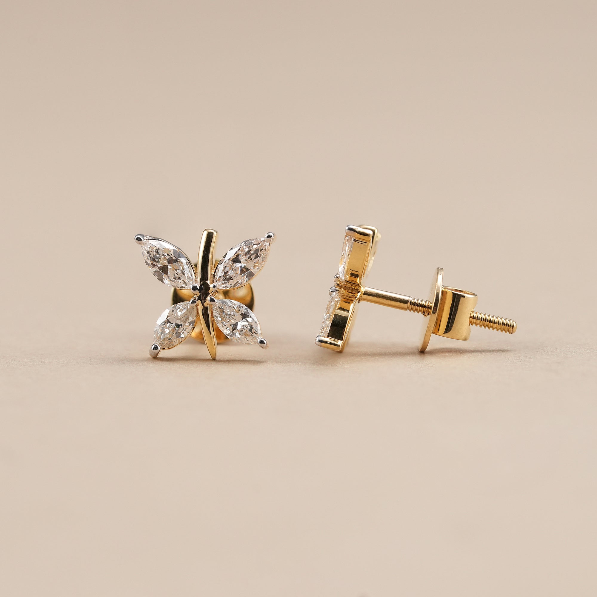 Marquise cut diamond stud earrings crafted in yellow gold