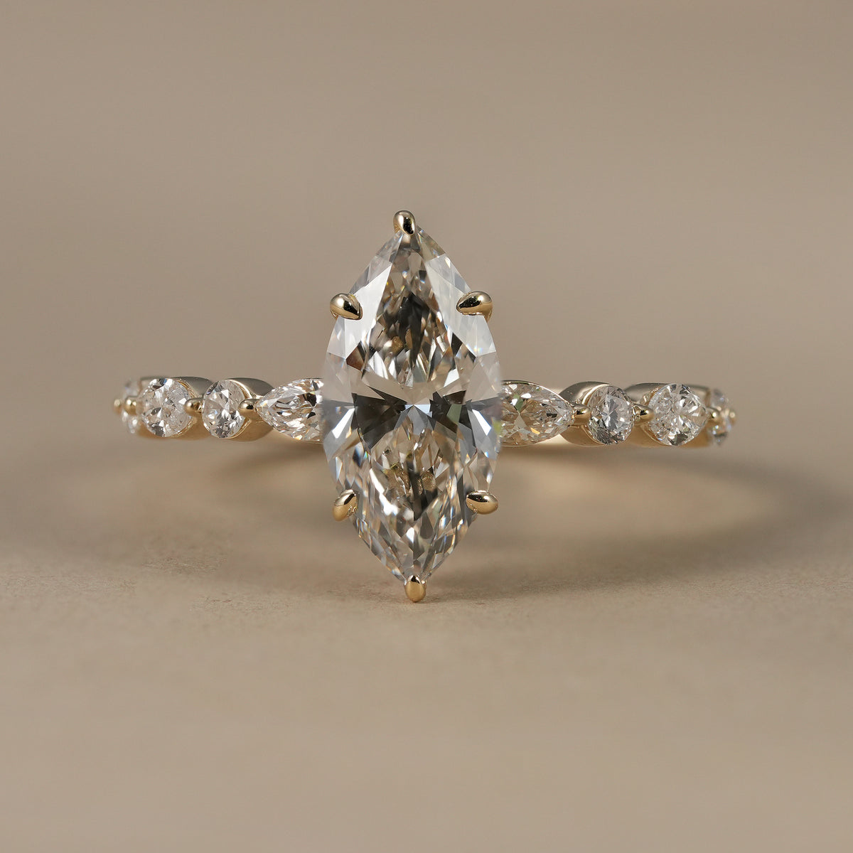 1.5 CT marquise lab grown diamond hidden halo engagement ring with round and marquise accents.