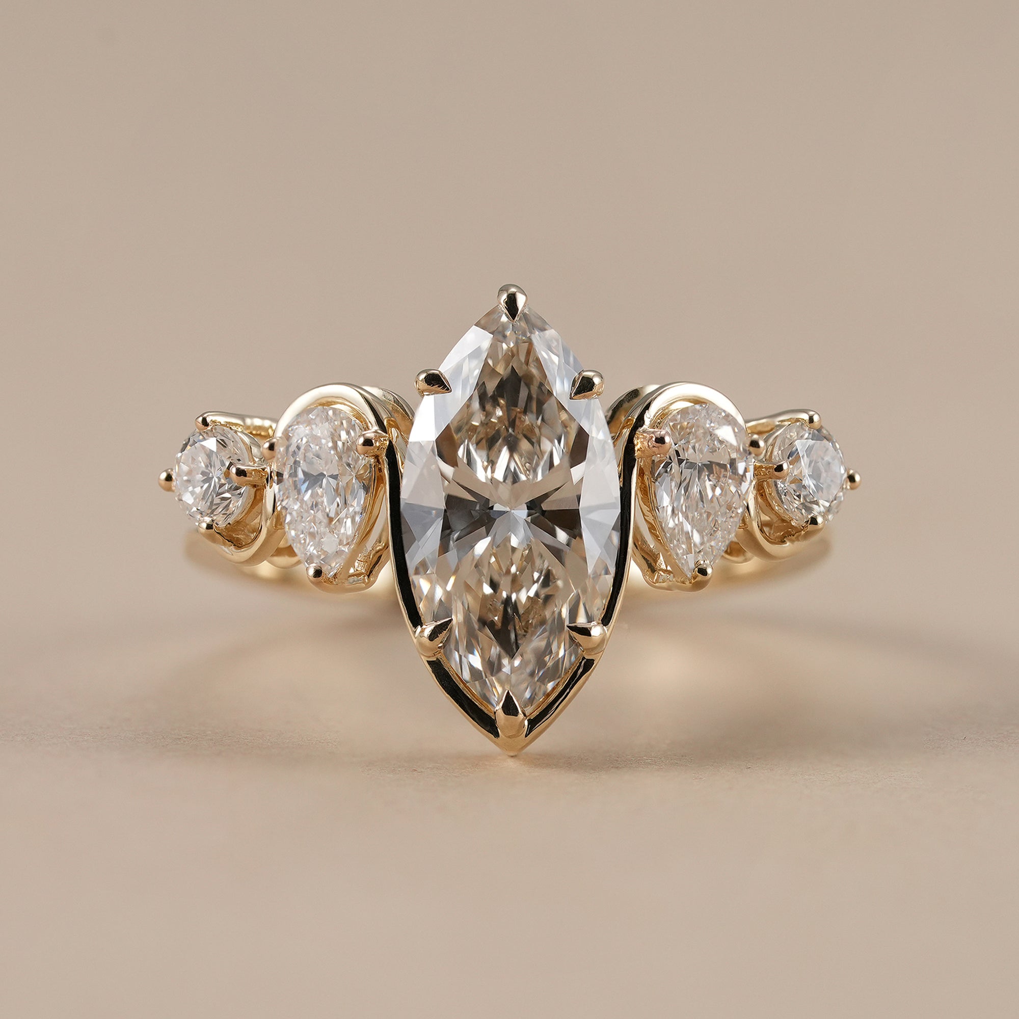 Marquise lab grown diamond ring with pear and round accent stones