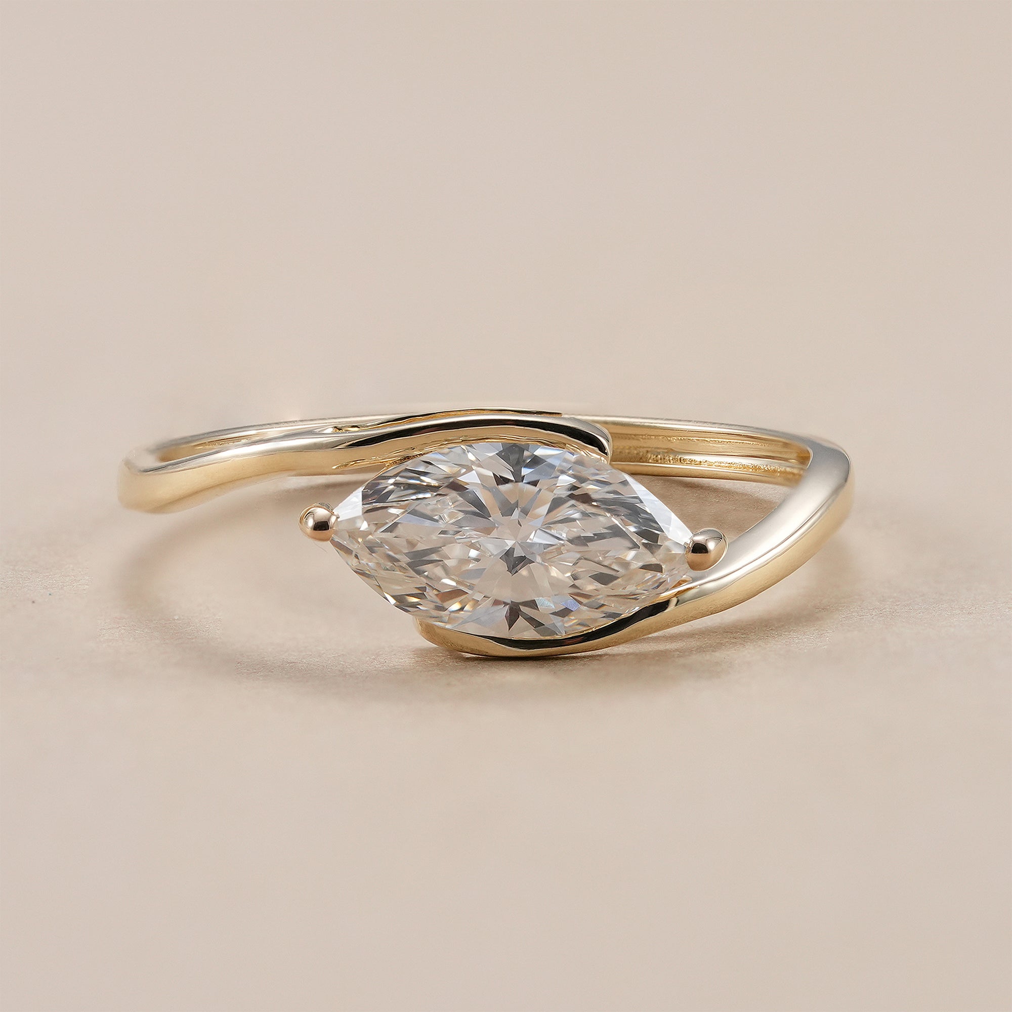 Marquise lab grown diamond bypass solitaire engagement ring in yellow gold.