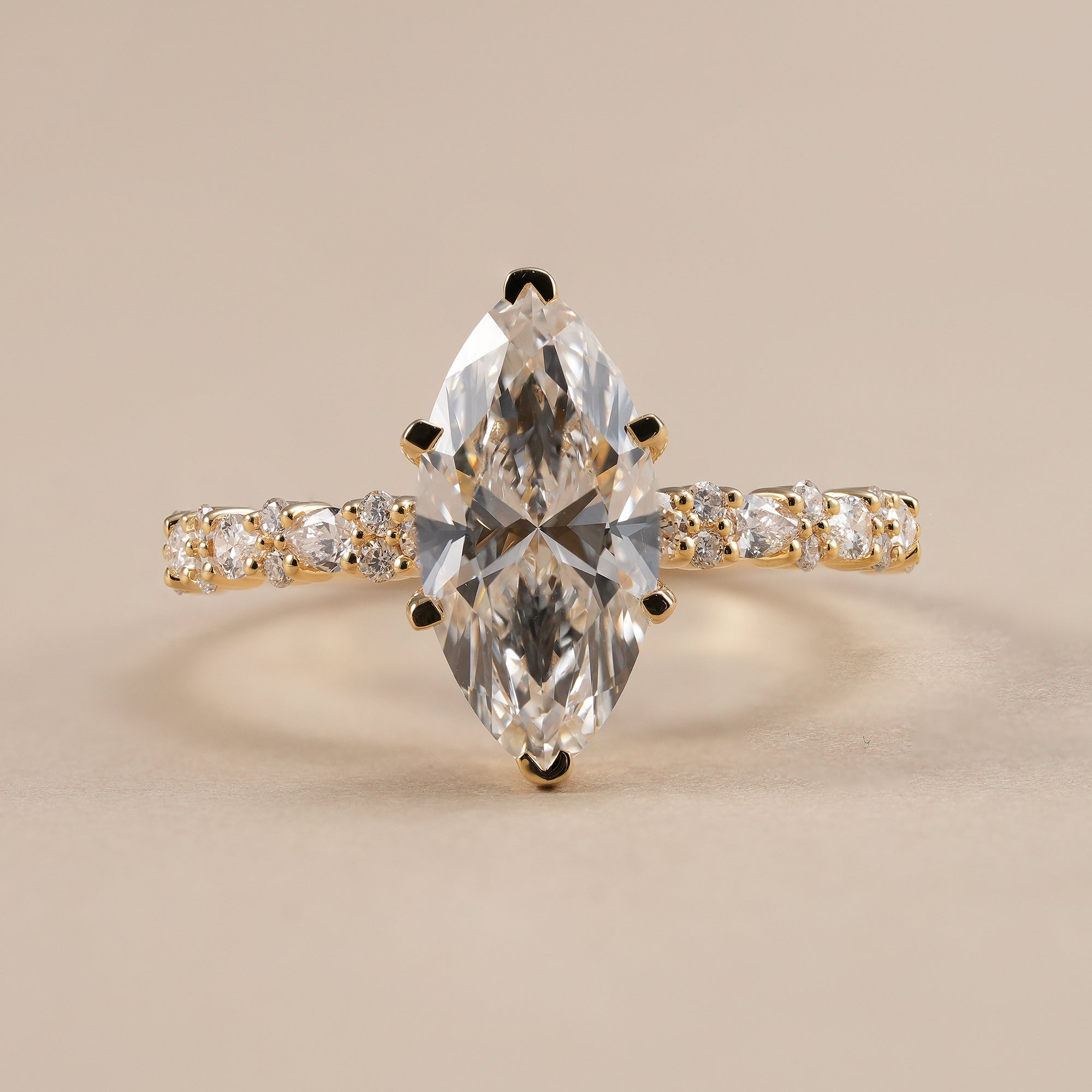 Marquise lab grown diamond engagement ring with round and pear accent band