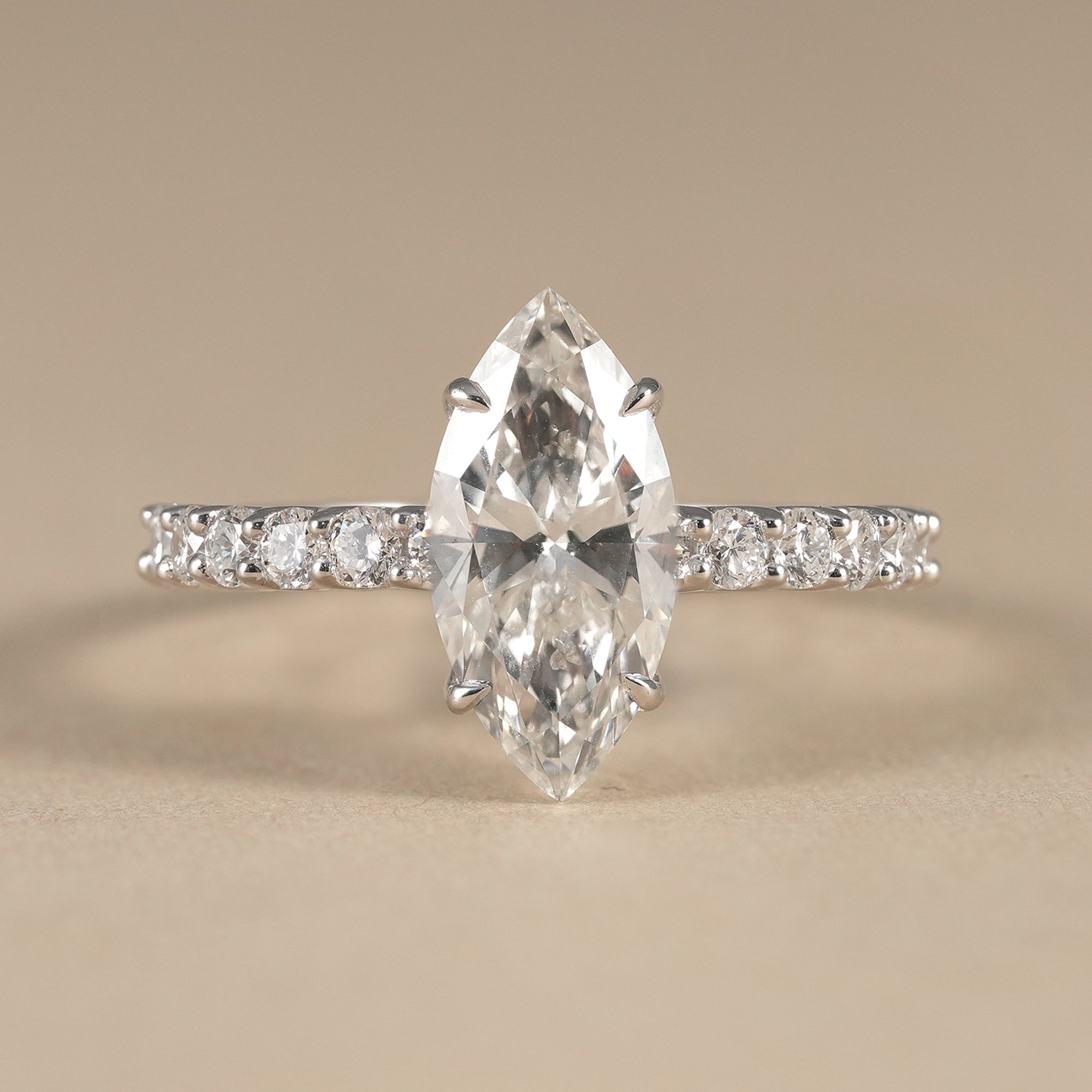 Marquise lab grown diamond engagement ring with round accent stones