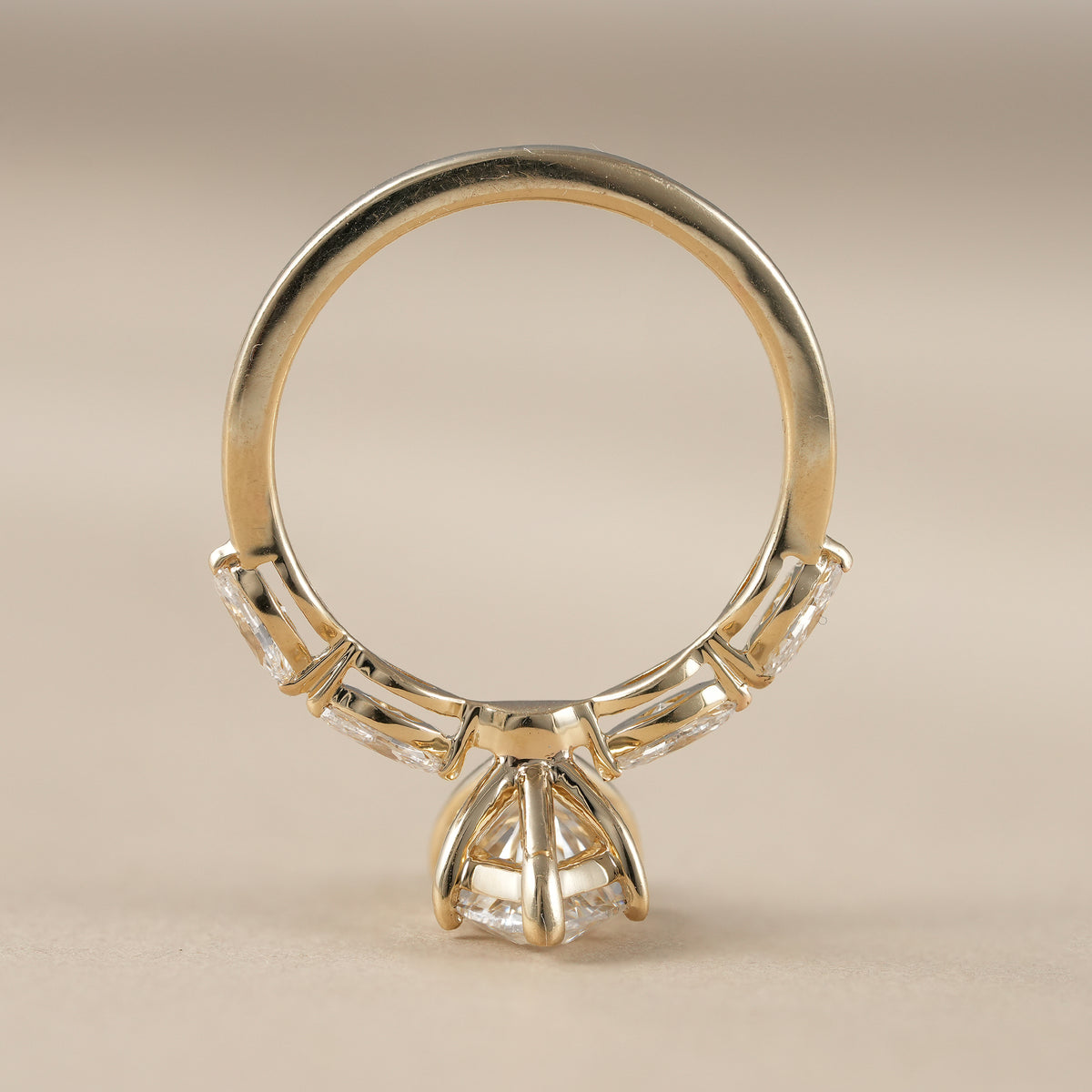 Elegant marquise lab diamond proposal ring with sparkling round and marquise side stones.
