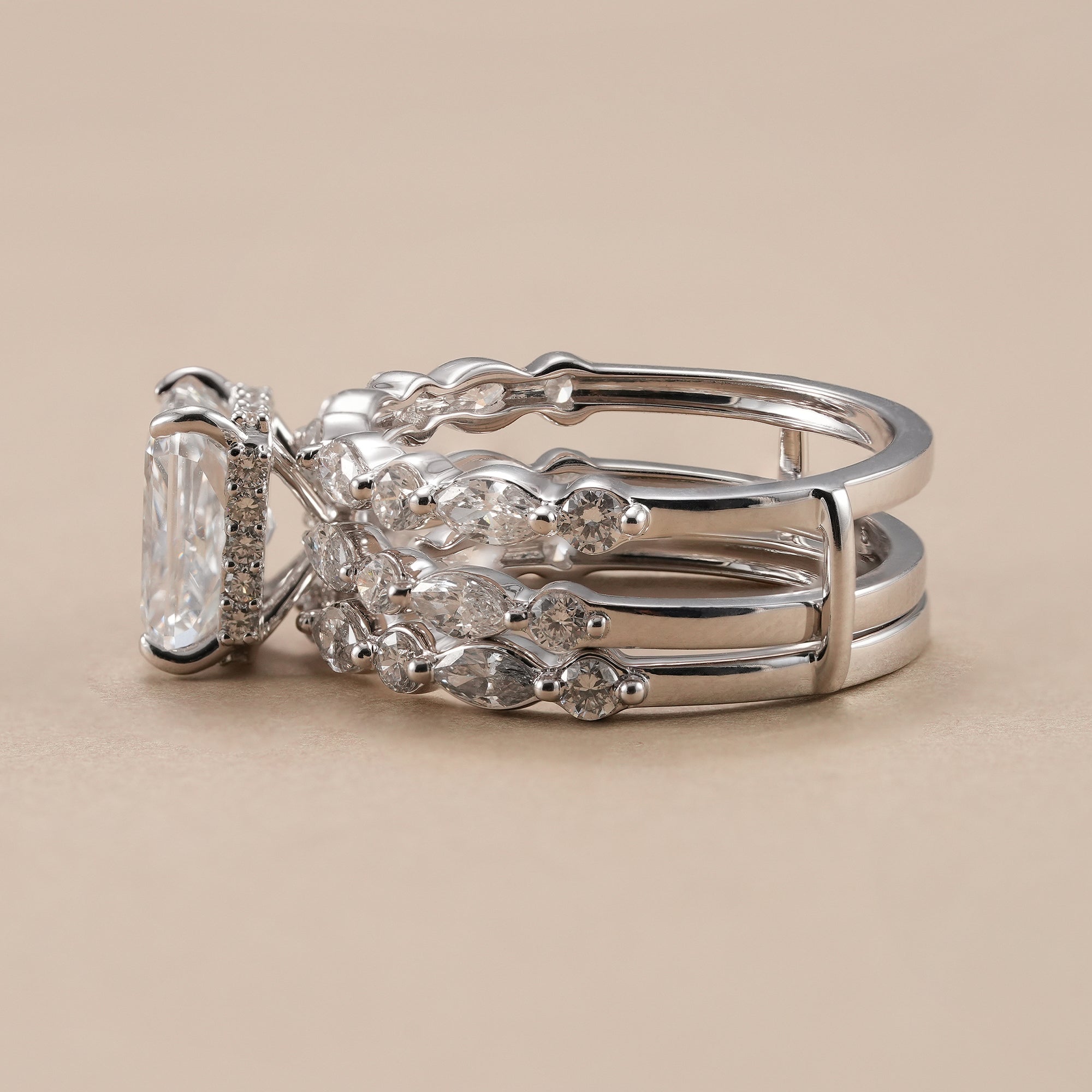 Radiant engagement ring with marquise and round diamond bands.