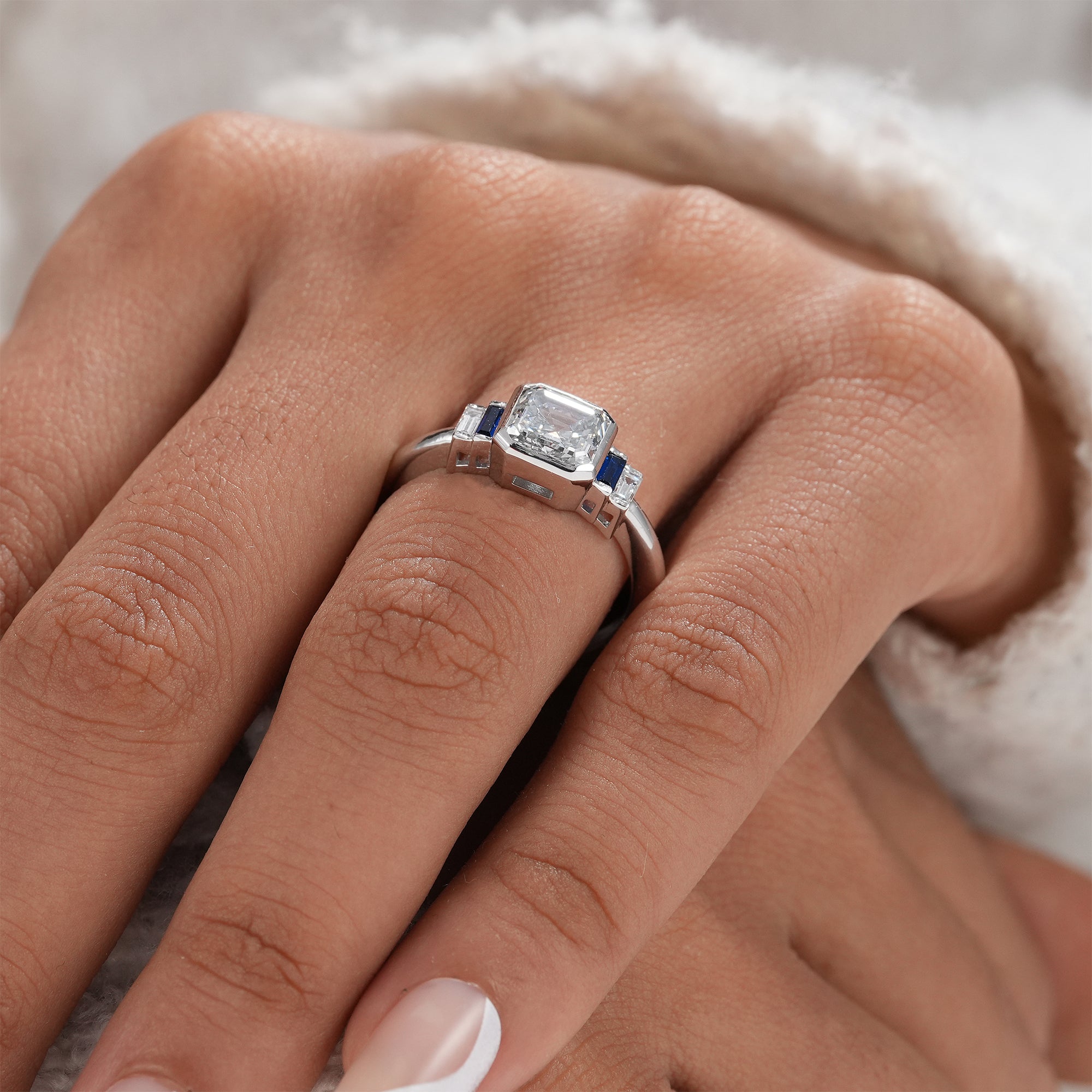 White gold engagement ring with Asscher diamond and baguette stones.