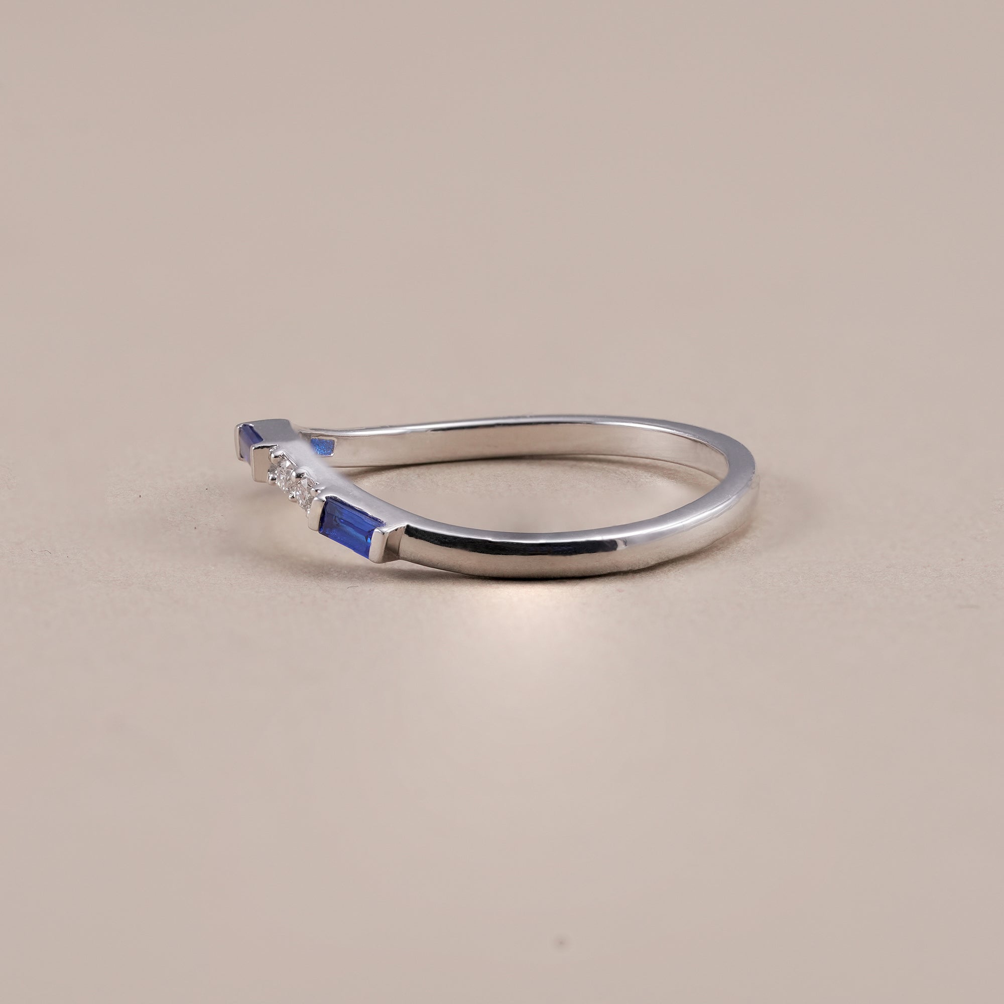 Lab grown diamond wedding band featuring blue baguette accents