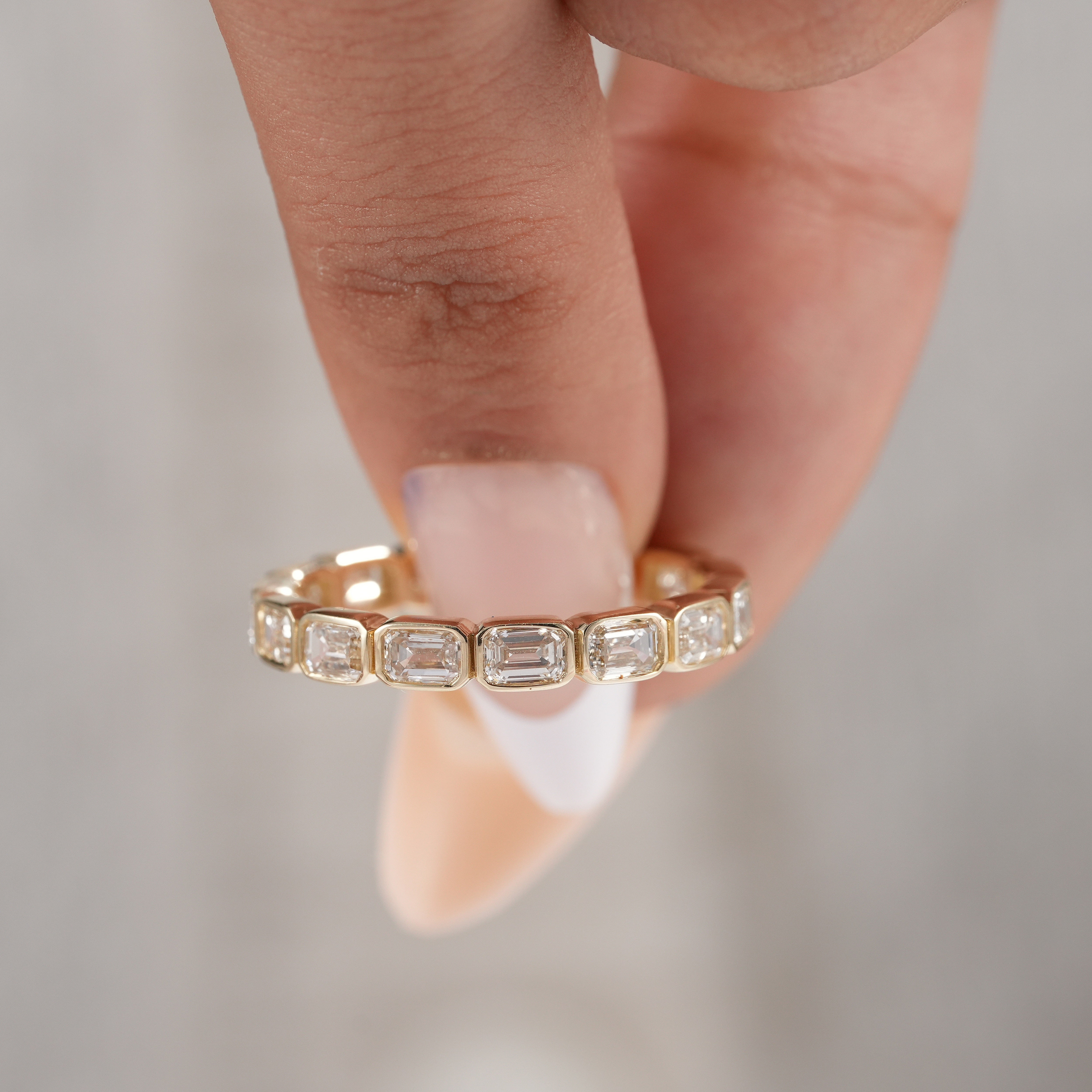 Sustainable lab grown emerald diamond eternity band.