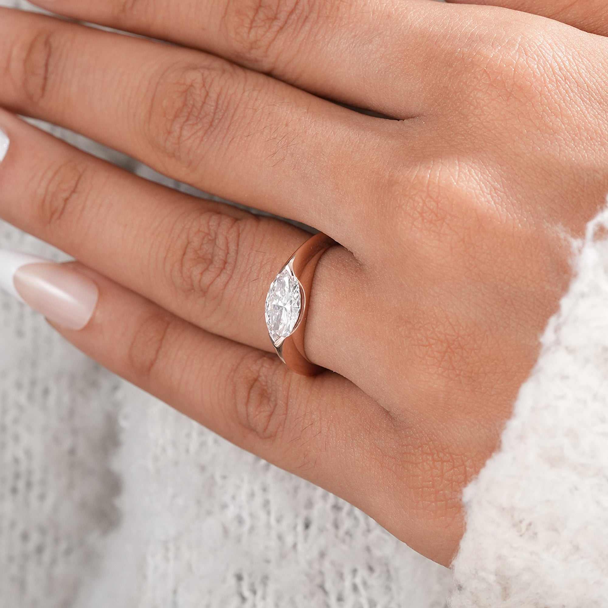 Contemporary marquise solitaire ring handcrafted in rose gold.