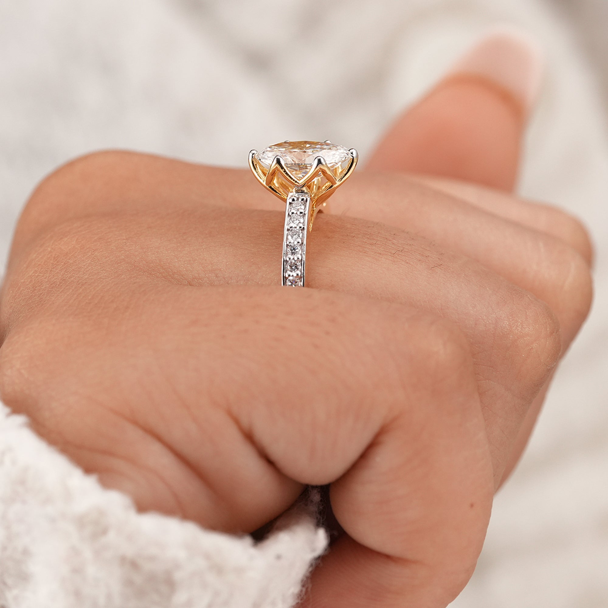 Classic oval engagement ring featuring pavé diamond accents