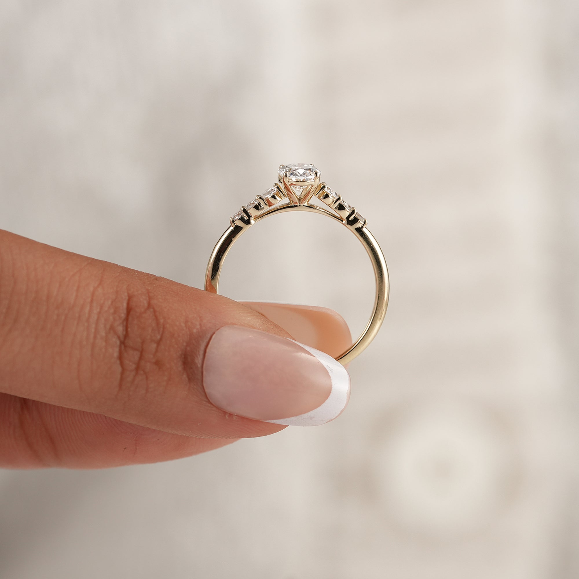 Luxury oval engagement ring with round and oval accent stones
