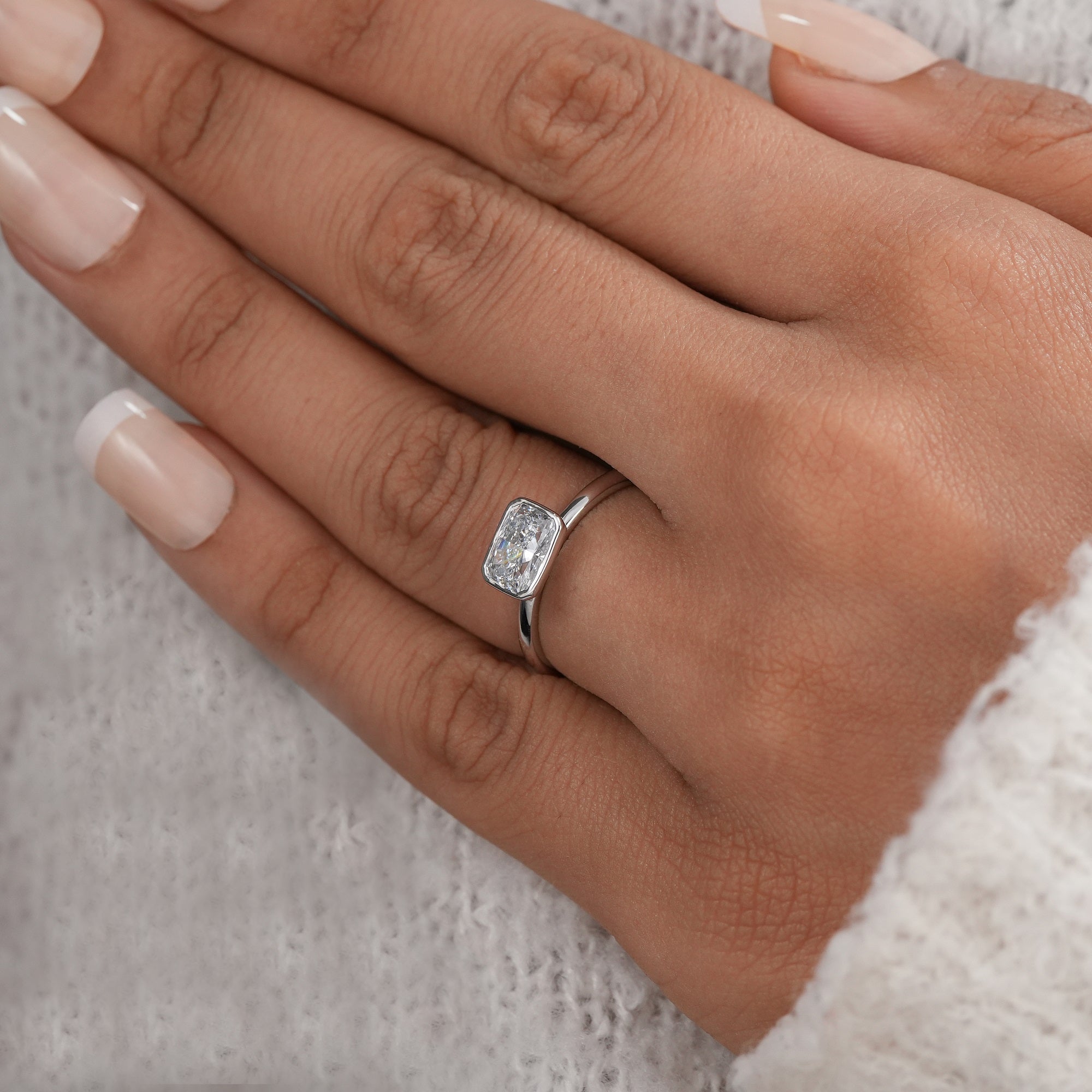 Elegant east west radiant solitaire diamond ring close up view