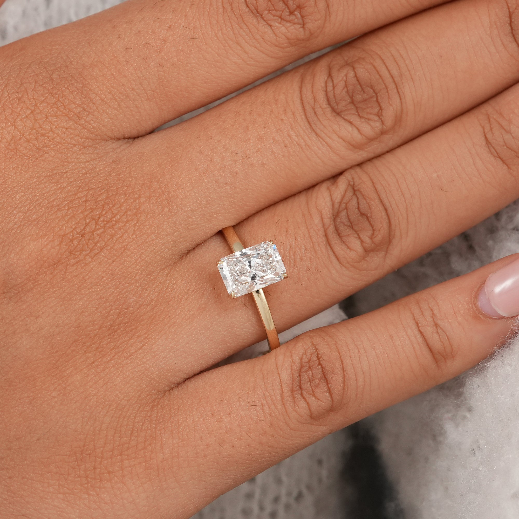 Classic solitaire engagement ring featuring radiant lab diamond.