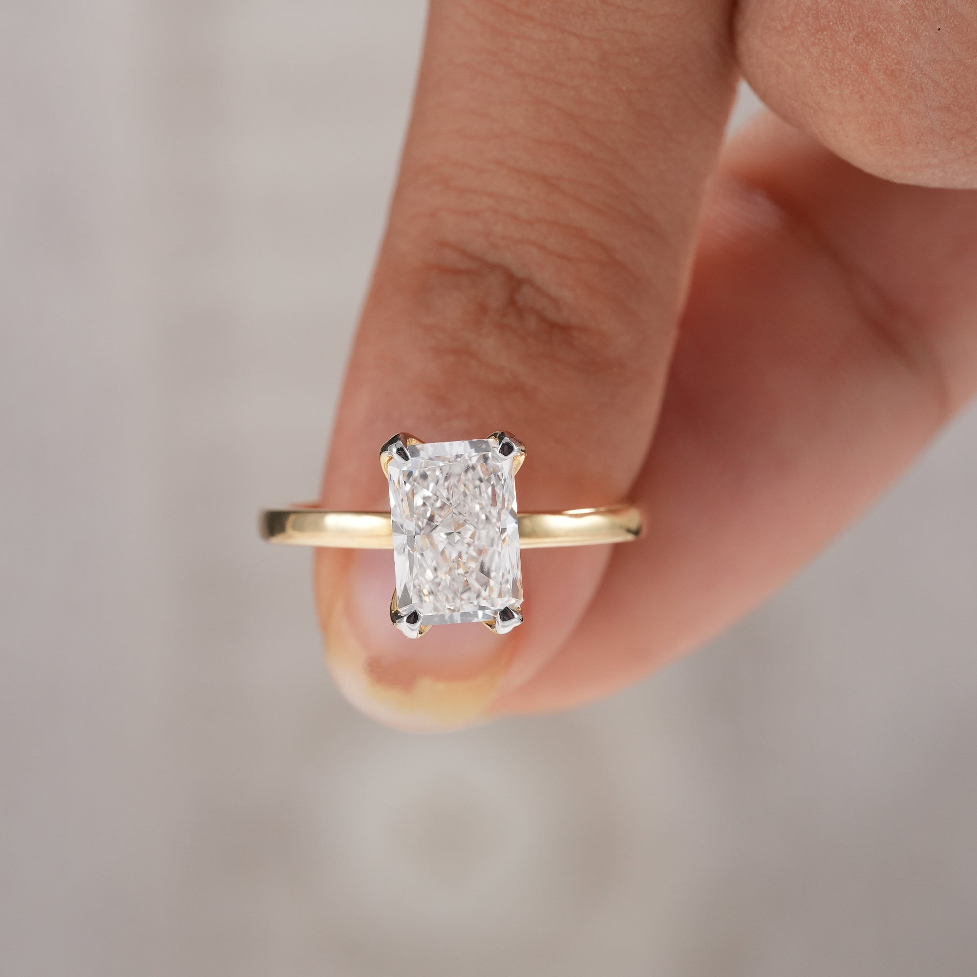 Classic solitaire engagement ring featuring radiant lab created diamond.