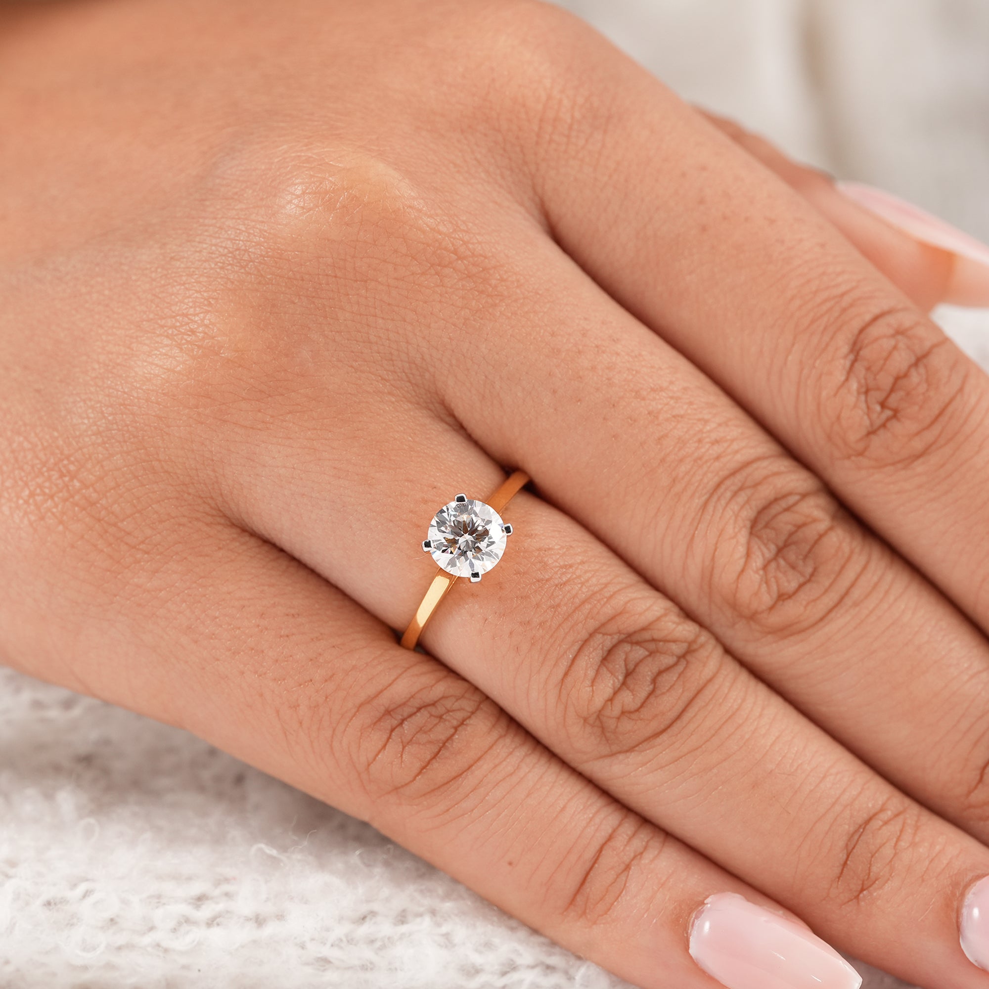 Minimalist round solitaire diamond ring featuring brilliant round cut center stone