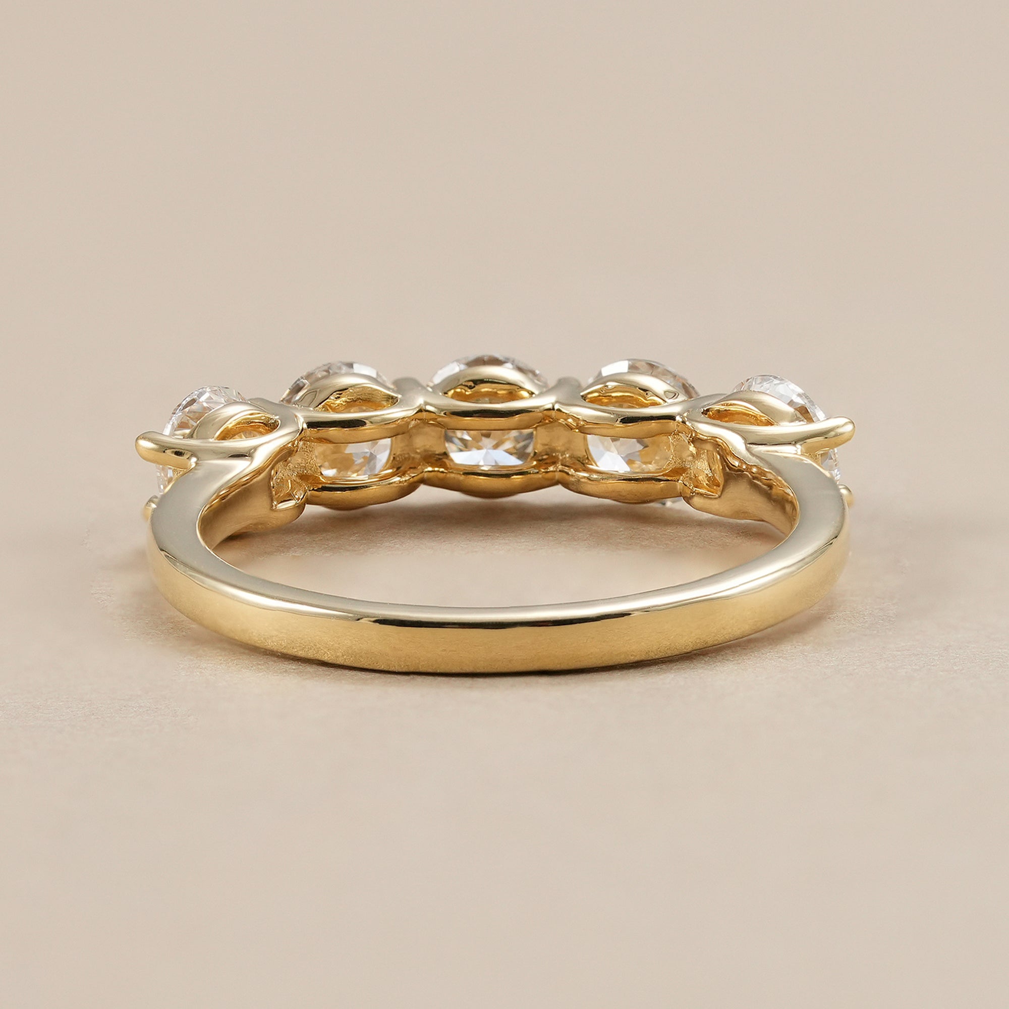 Minimalist lab grown diamond wedding band with five stones.