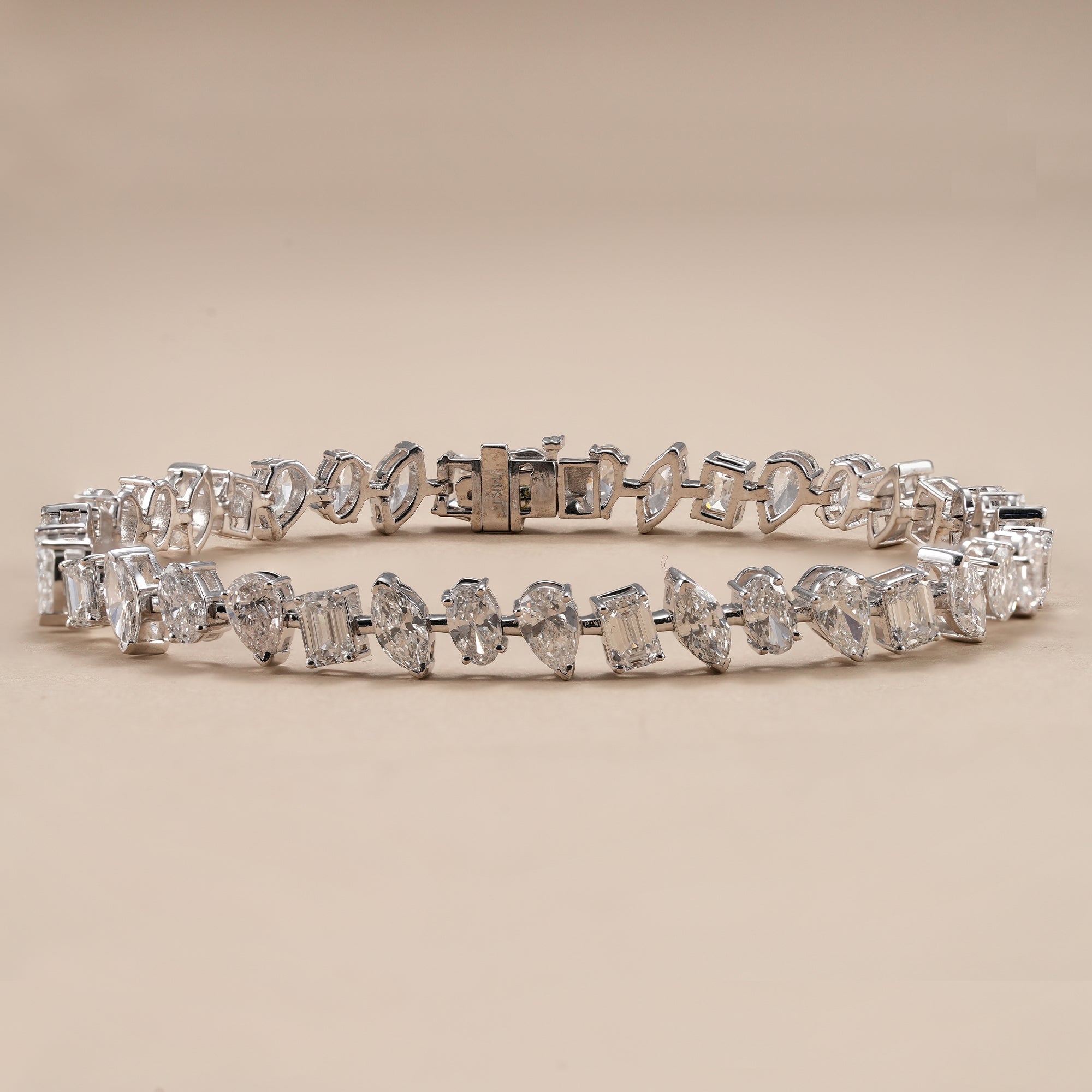 Mixed shape lab diamond tennis bracelet featuring emerald, pear, oval and marquise cut diamonds.