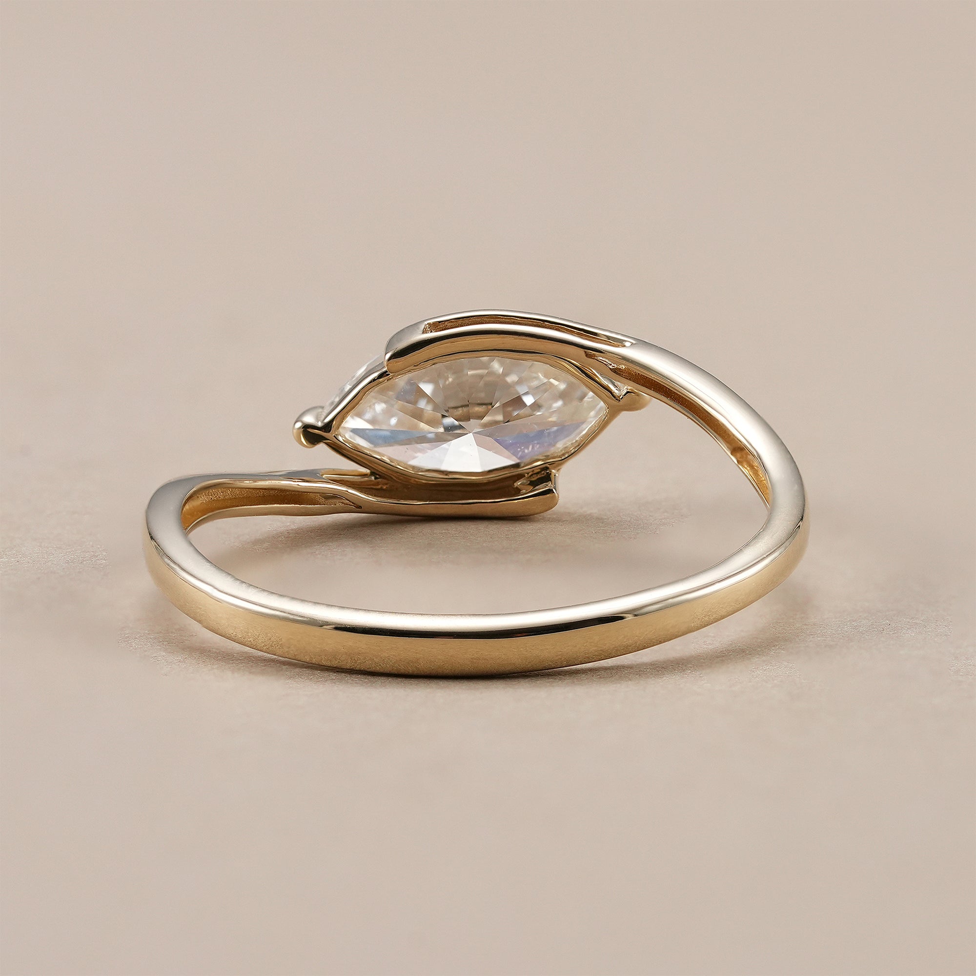 Minimalist marquise solitaire ring with bypass shank.