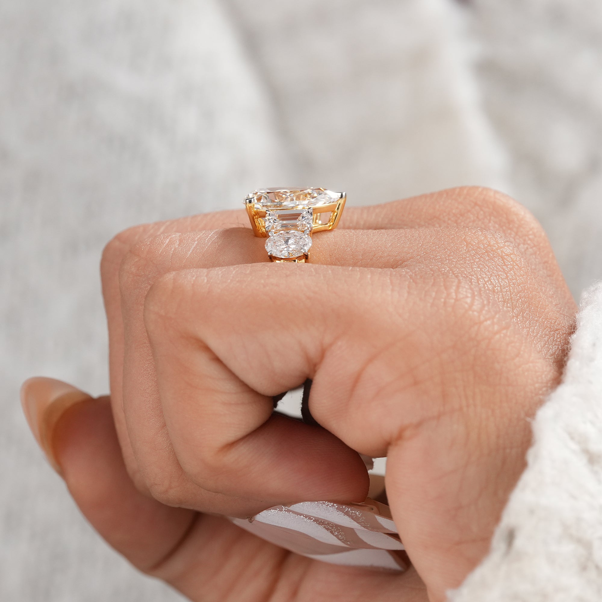 Oval and emerald side stone pear engagement ring.