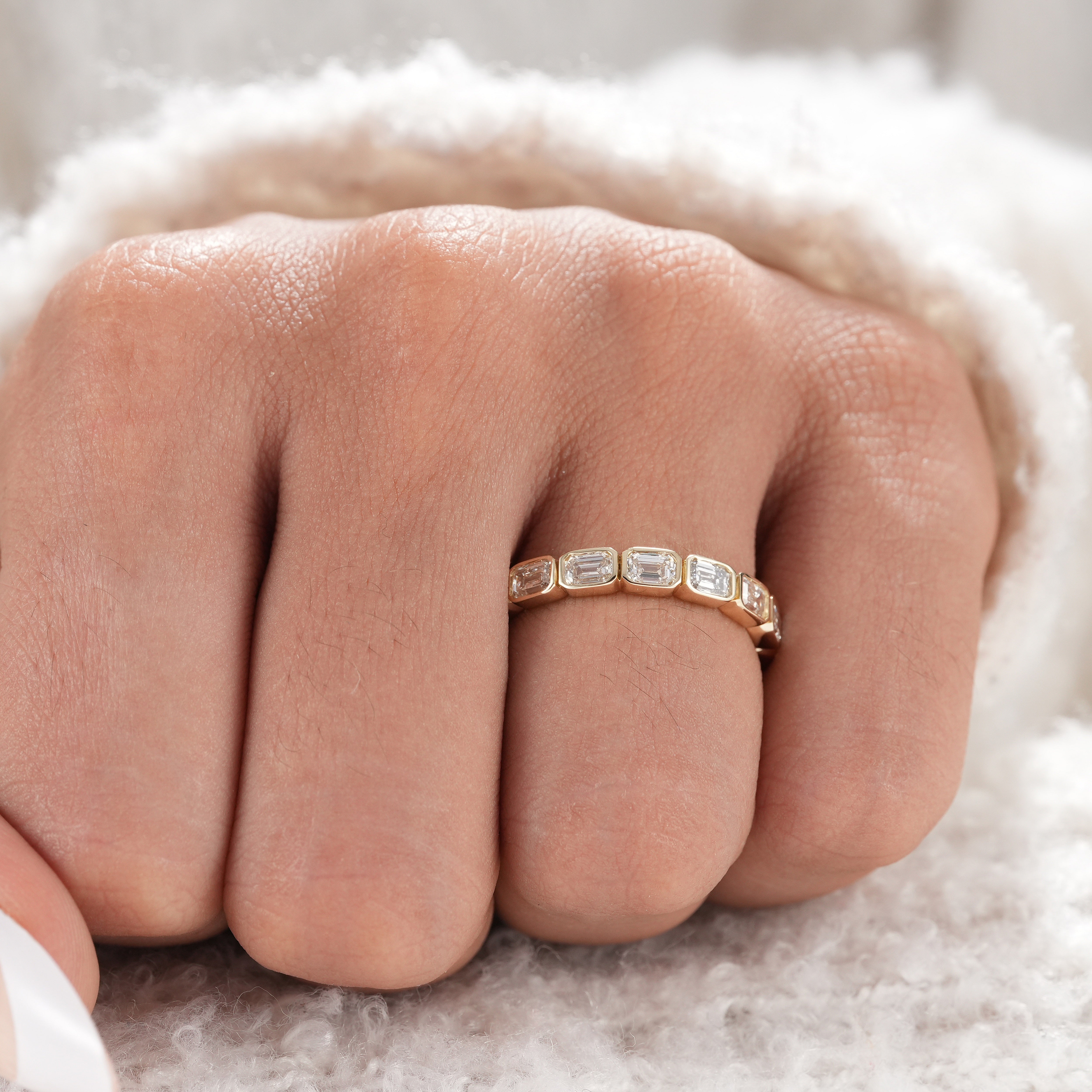 Elegant bezel set emerald cut diamond ring for women.