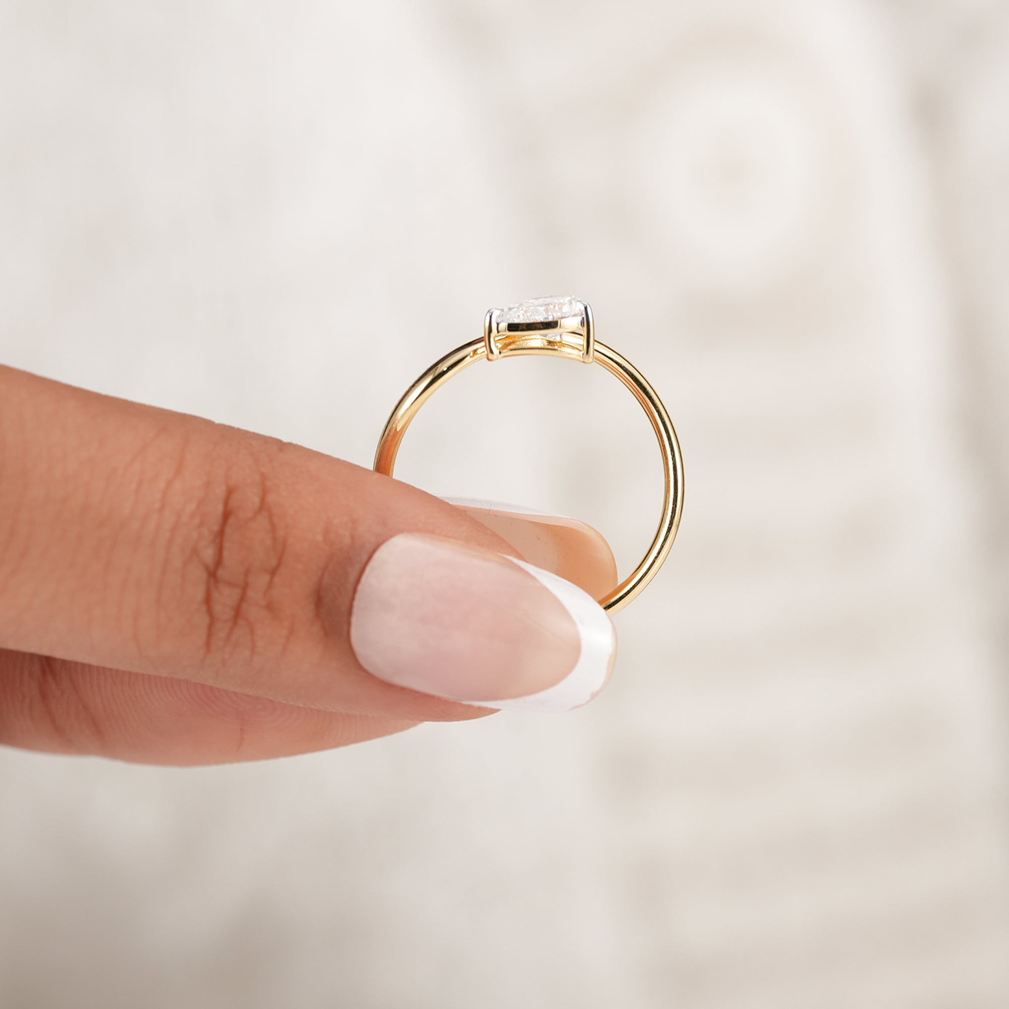 Freeform pear diamond anniversary ring in yellow gold
