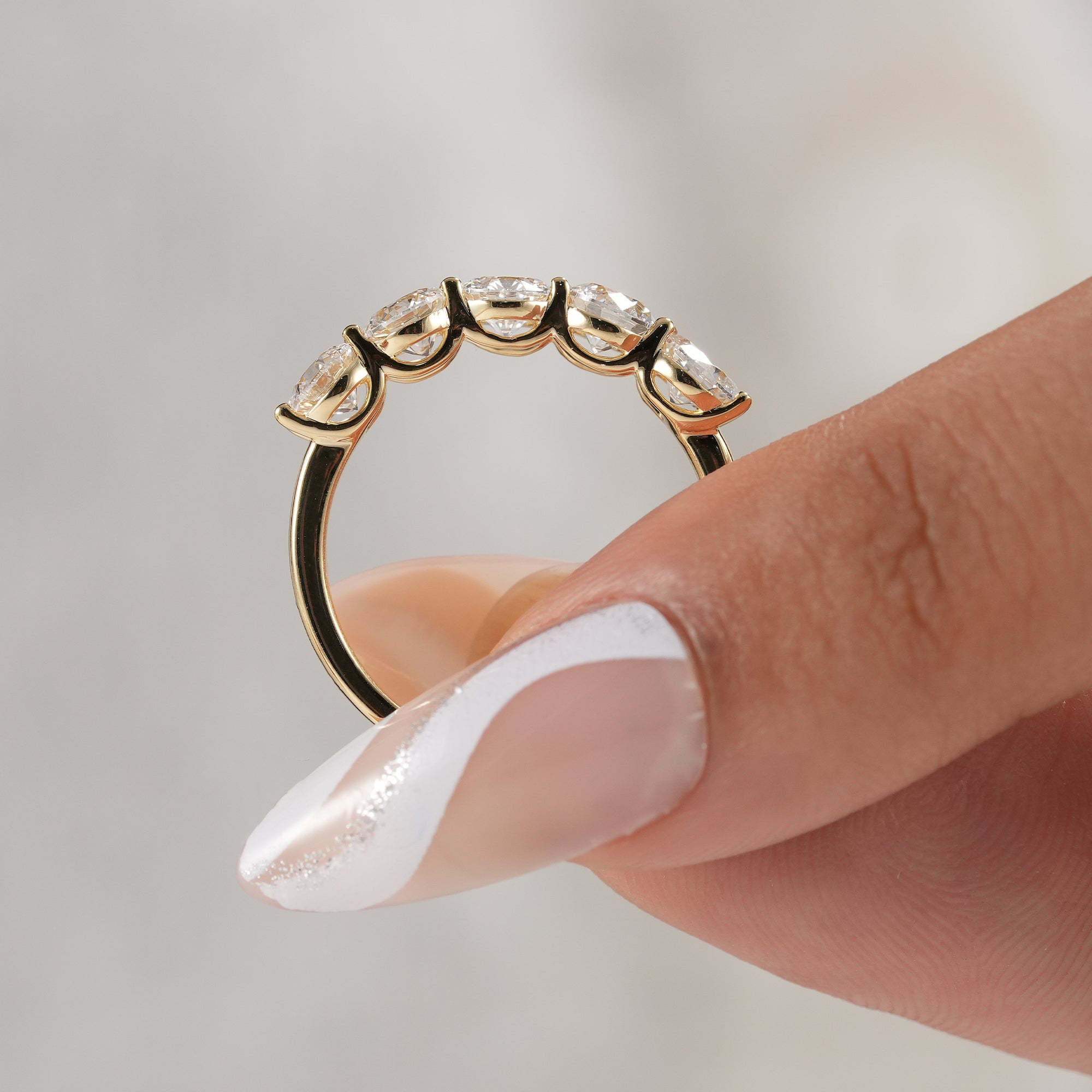 Women's handcrafted round diamond bridal band.
