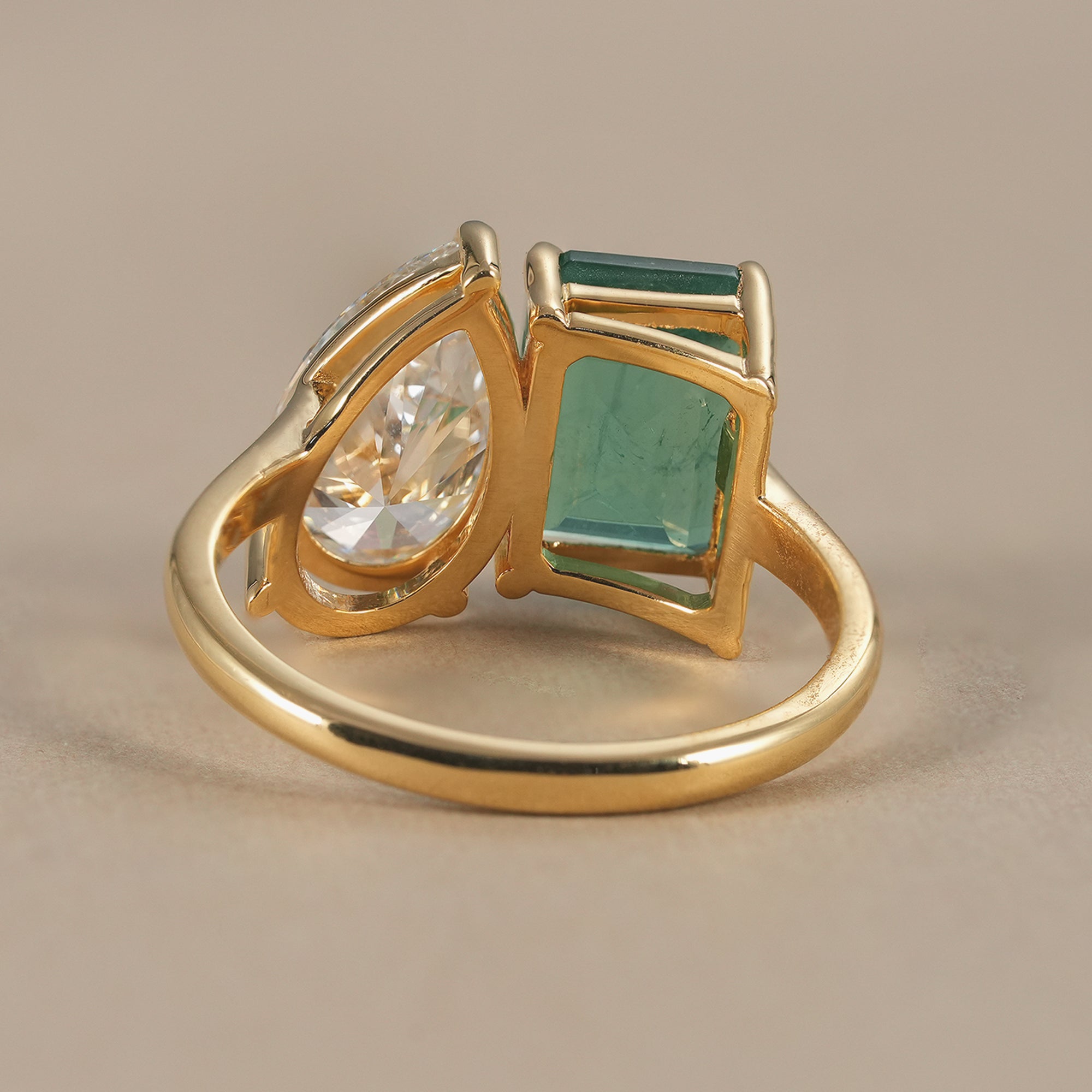 Sustainable emerald and pear diamond engagement ring