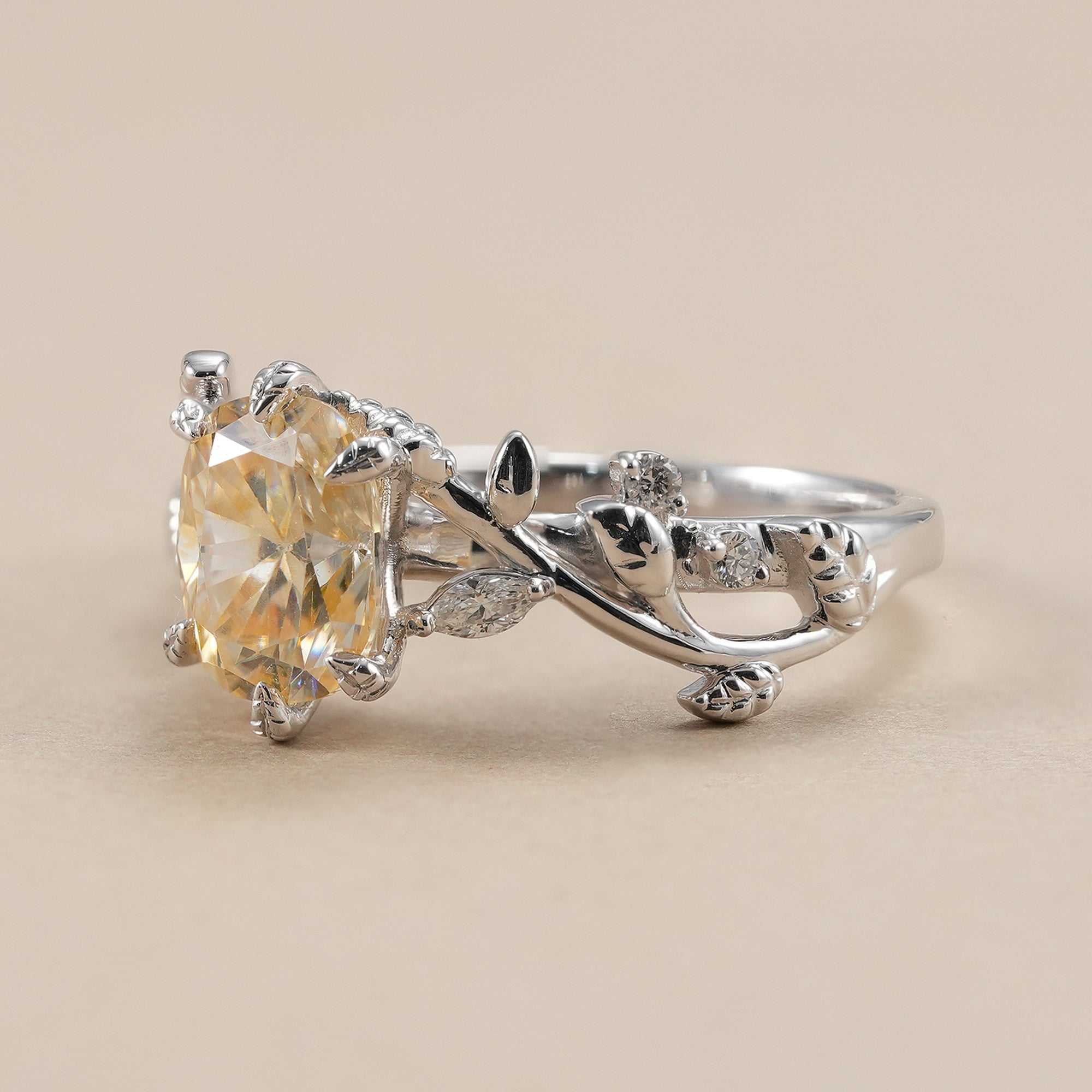 Cushion cut yellow lab diamond ring featuring floral vine design.
