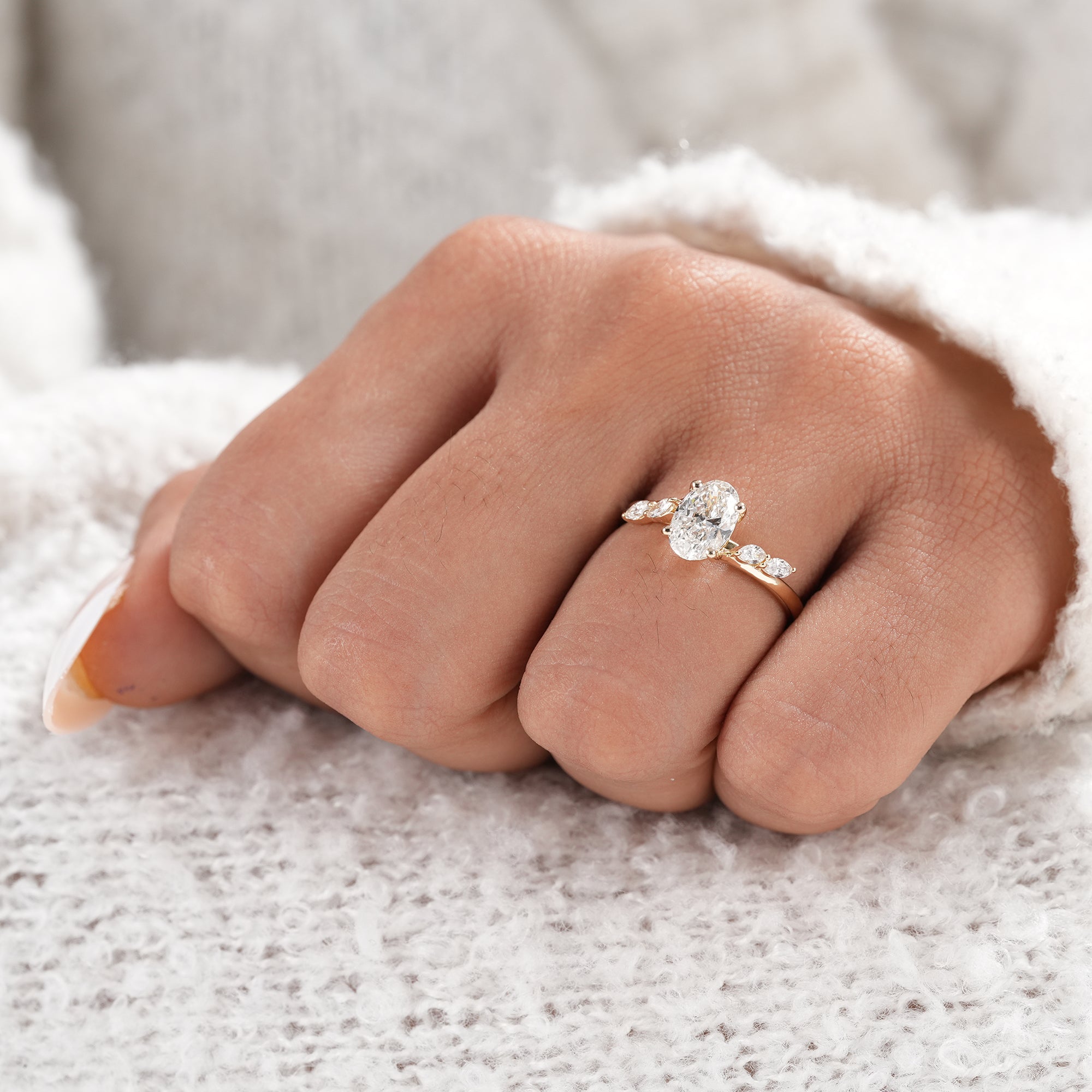 Handmade oval diamond ring with marquise accent diamonds.