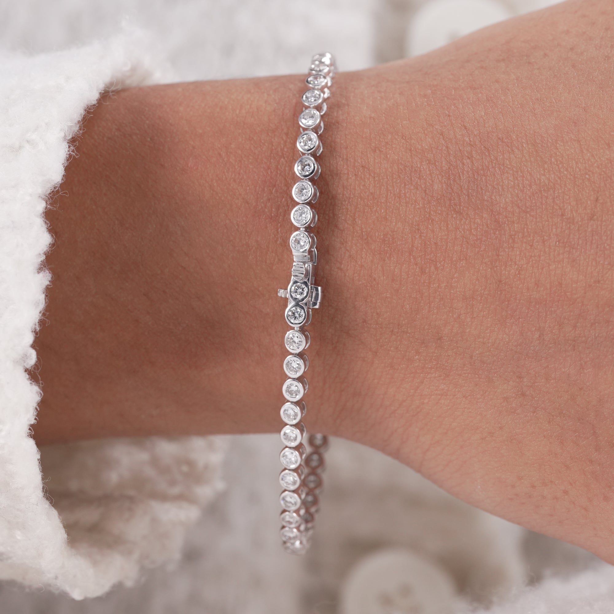 Sparkling lab grown diamond tennis bracelet with modern bezel setting.