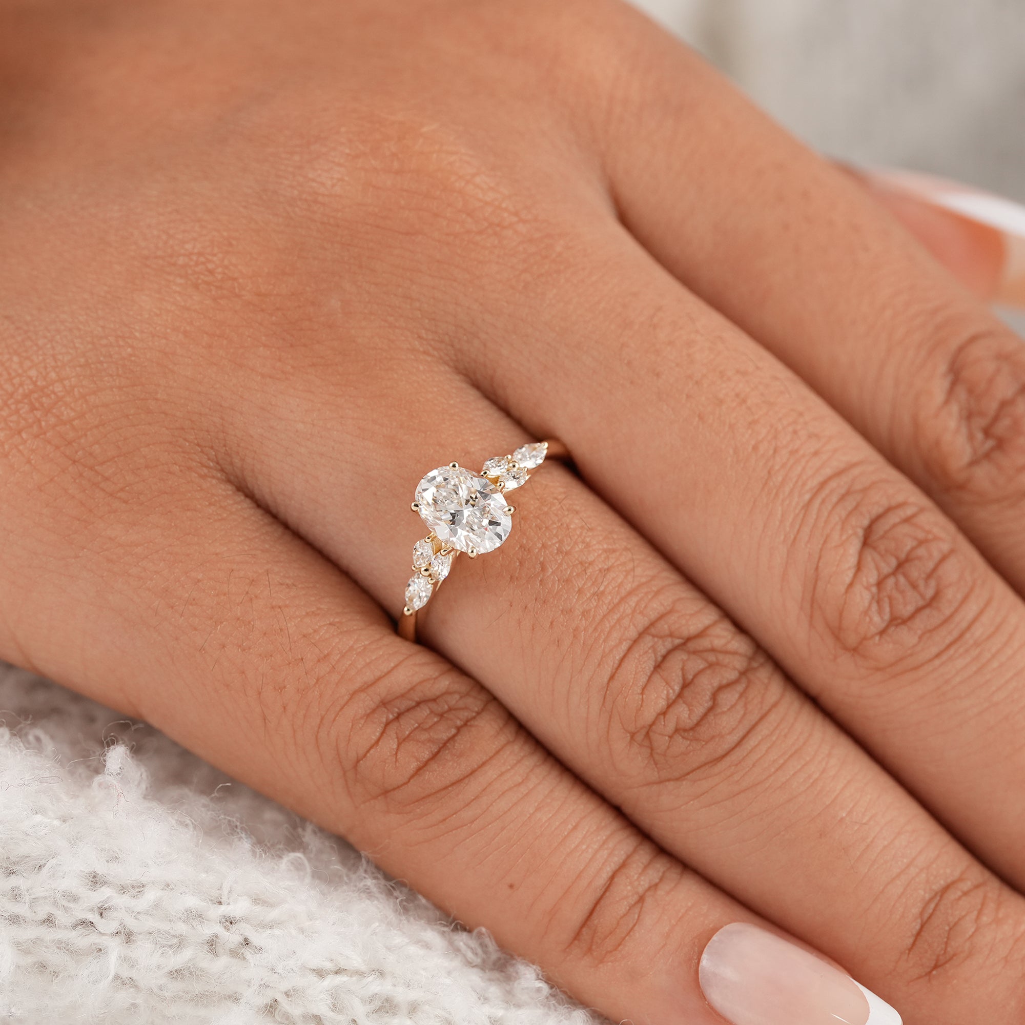 Oval floral diamond ring with marquise side stones